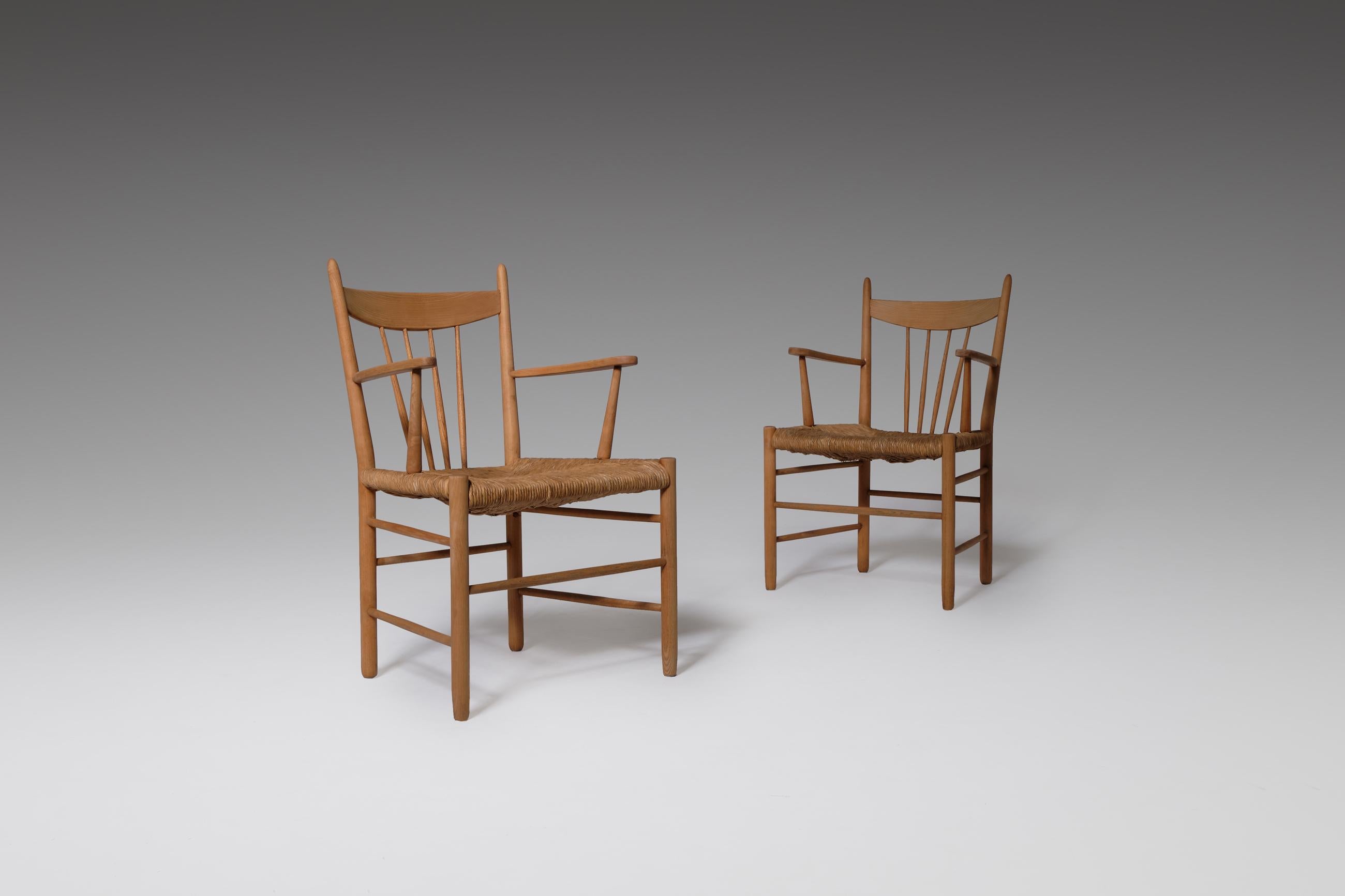 Scandinavian Modern side chairs in solid oak and rush, Denmark, 1950s. A modest and traditional design in solid oak and elegantly woven rush seat. The materials provide a nice rustic yet modern appearance. In original condition with beautiful