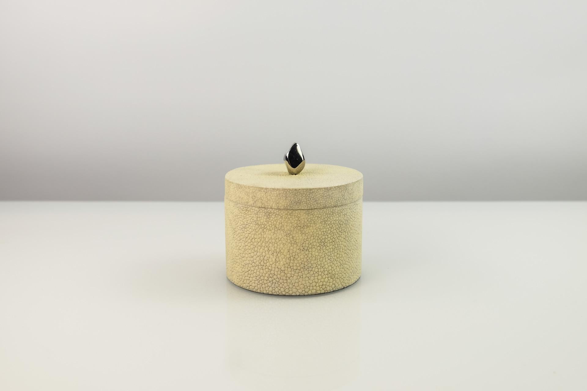 This set of 2 round boxes is made of shagreen.
These boxes have a nickel brass handle. 

They are lined with a black micro suede.

The color of this box is natural.

The dimensions of each piece is:
diameter 3.34