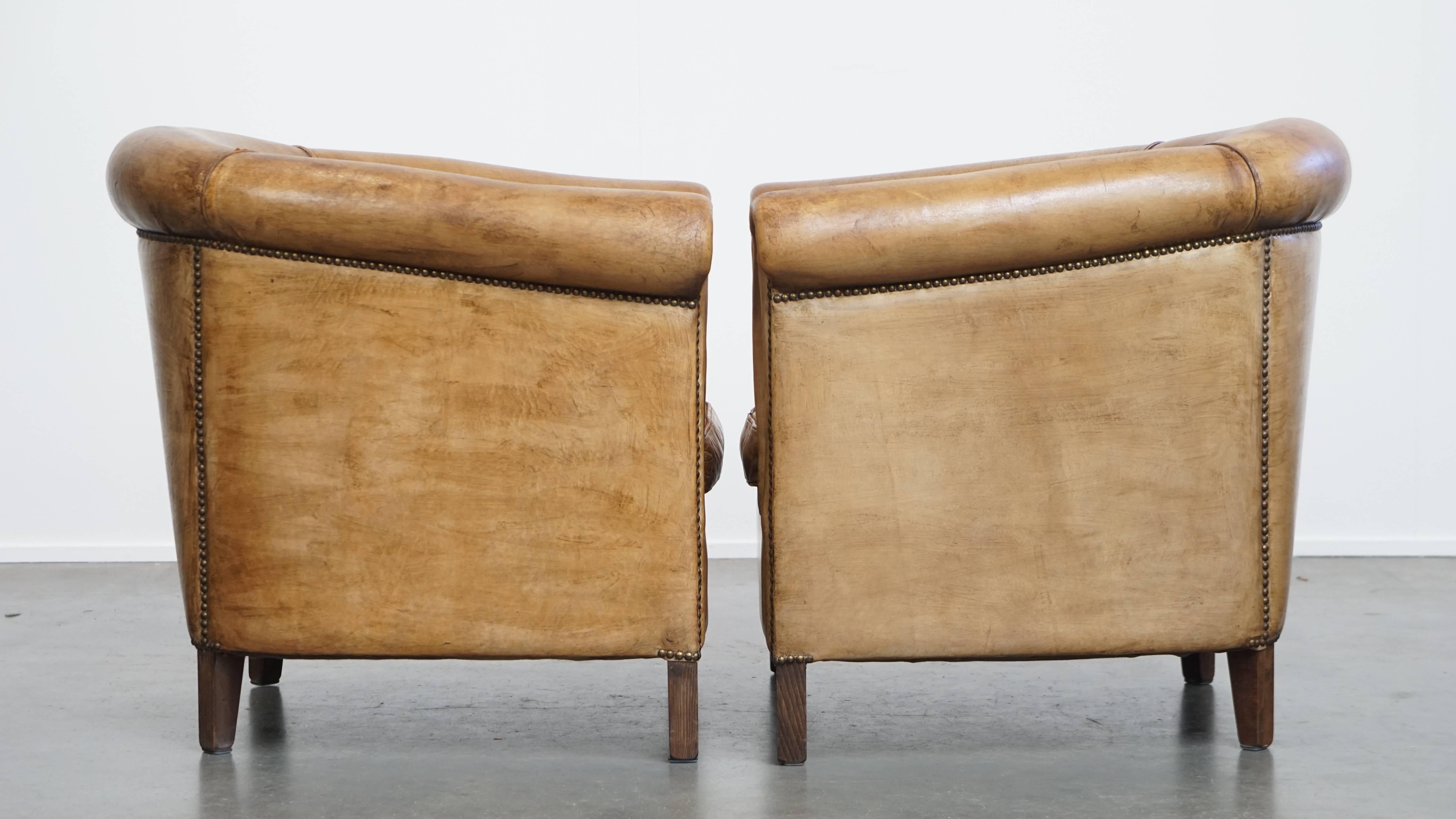 Offered here is a set of 2 timeless and stylish sheepskin leather club chairs by Nico van Oorschot in beautiful colors. 

These two club chairs were designed by Nico van Oorschot and are crafted from high-quality sheepskin leather. They exude
