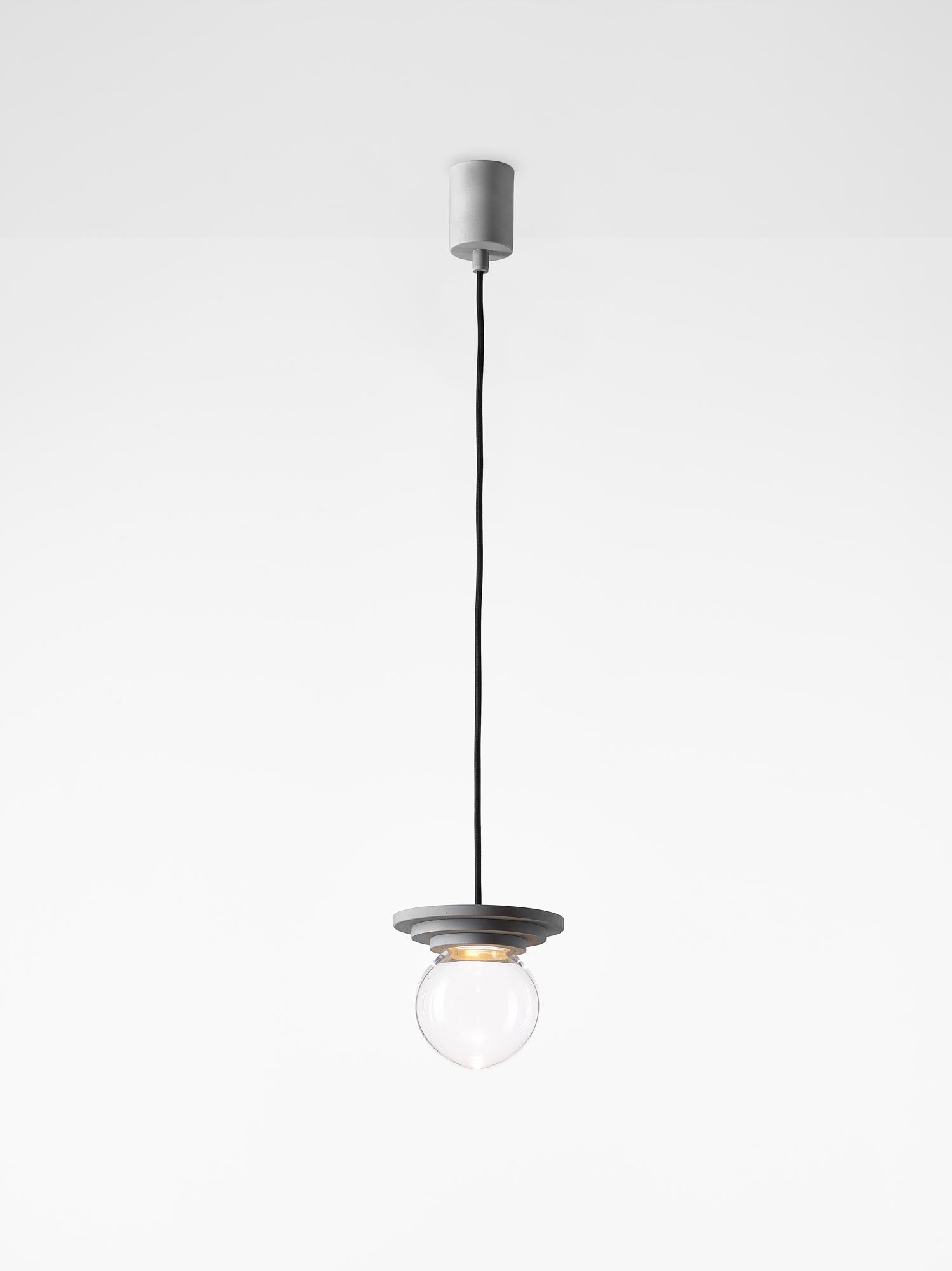Set of 2 silver and clear stratos mini ball pendant light by Dechem Studio
Dimensions: D 12 x H 14 cm
Materials: Aluminum, Glass.
Also available: Different colours available.

Different shapes of capsules and spheres contrast with anodized