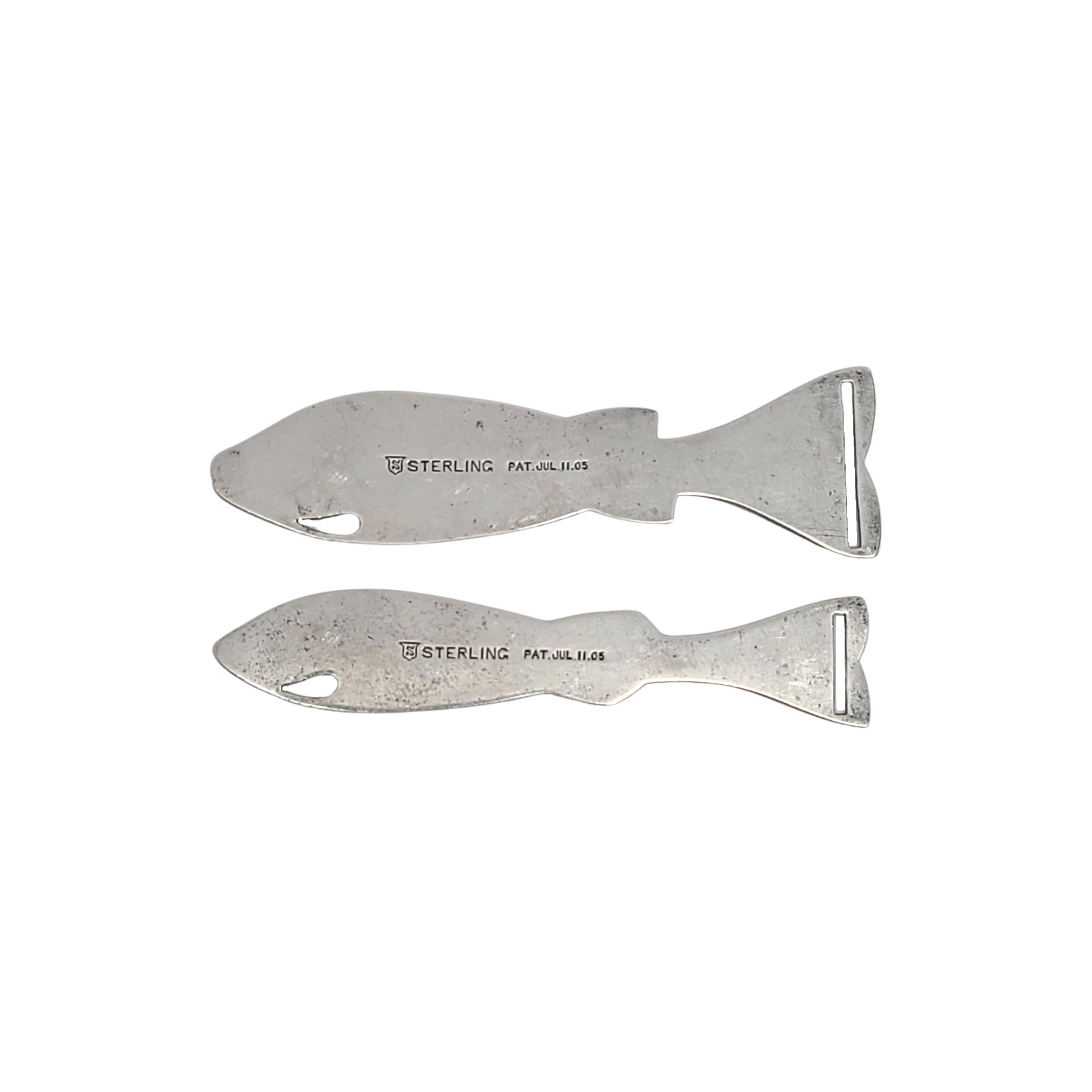 Set of 2 antique sterling silver ribbon threaders/bobkins in the shape of fish by Simon Brothers.

A set of 2 intricately detailed sewing tools in the shape of fish, the mouth hole is for thread or thinner ribbon, the slot in the tail is for thicker