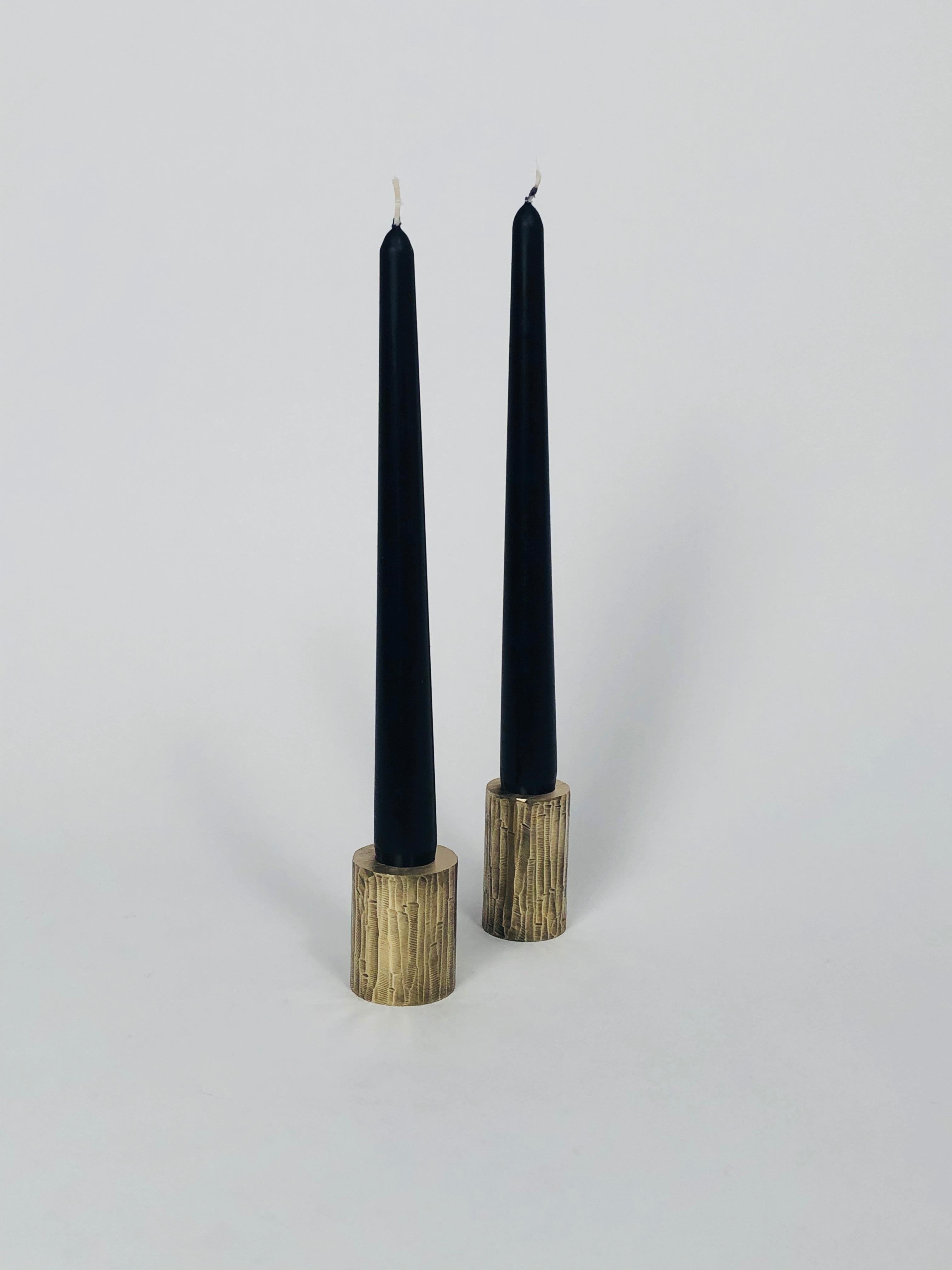 Set of 2 solid brass sculpted candleholders by William Guillon 
Each is signed William Guillon
Dimensions: Diameter 4 x height 5 cm
 Diameter 3.5 x height 6 cm
Materials: Solid brass raw finish or patinated black, with polished edge
Hand-sculpted in