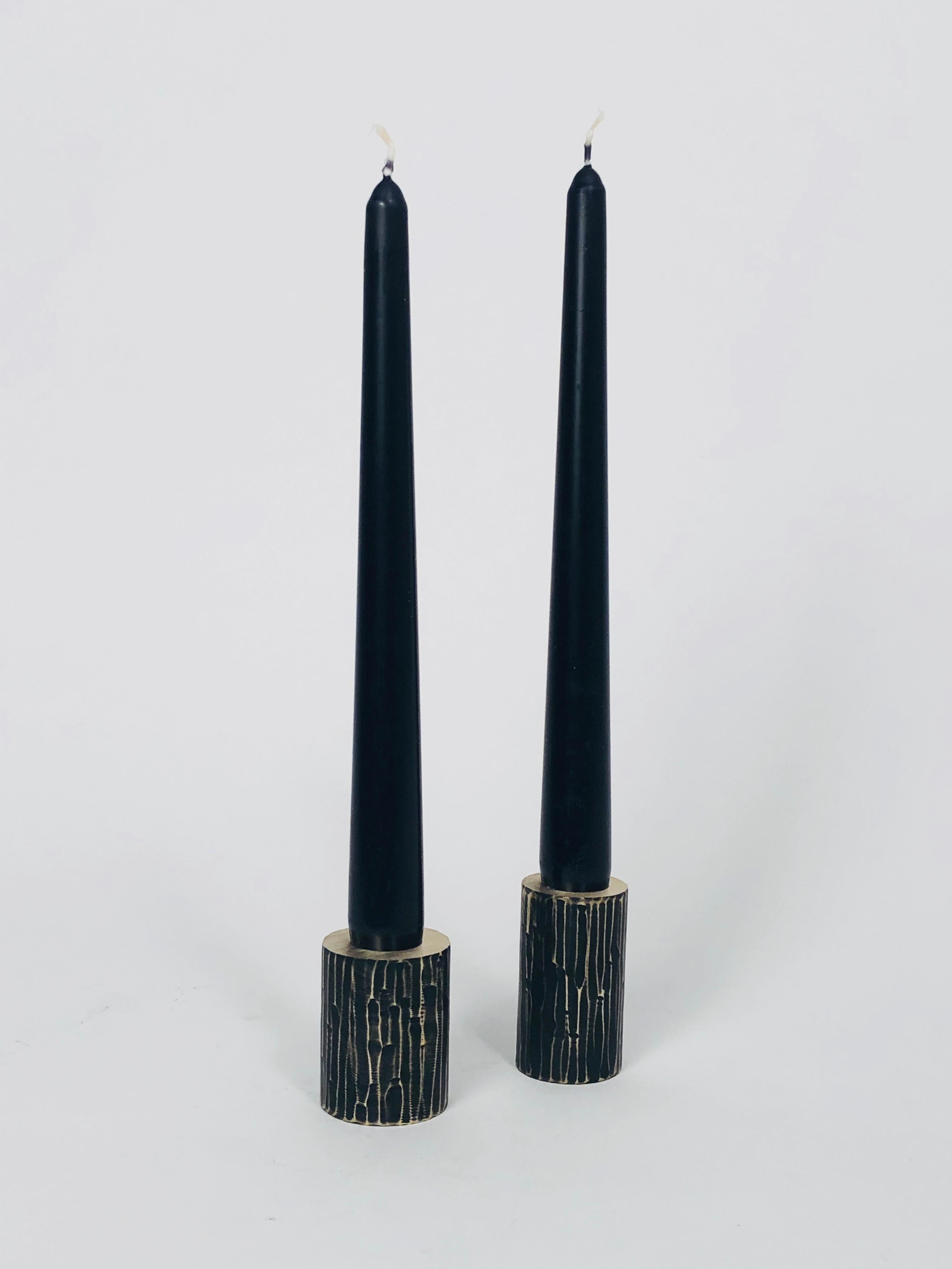 Set of 2 solid brass sculpted candleholders by William Guillon 
Each is signed William Guillon
Dimensions: Diameter 4 x height 5 cm
 Diameter 3.5 x height 6 cm
Materials: Solid brass raw finish or patinated black, with polished edge
Hand-sculpted in