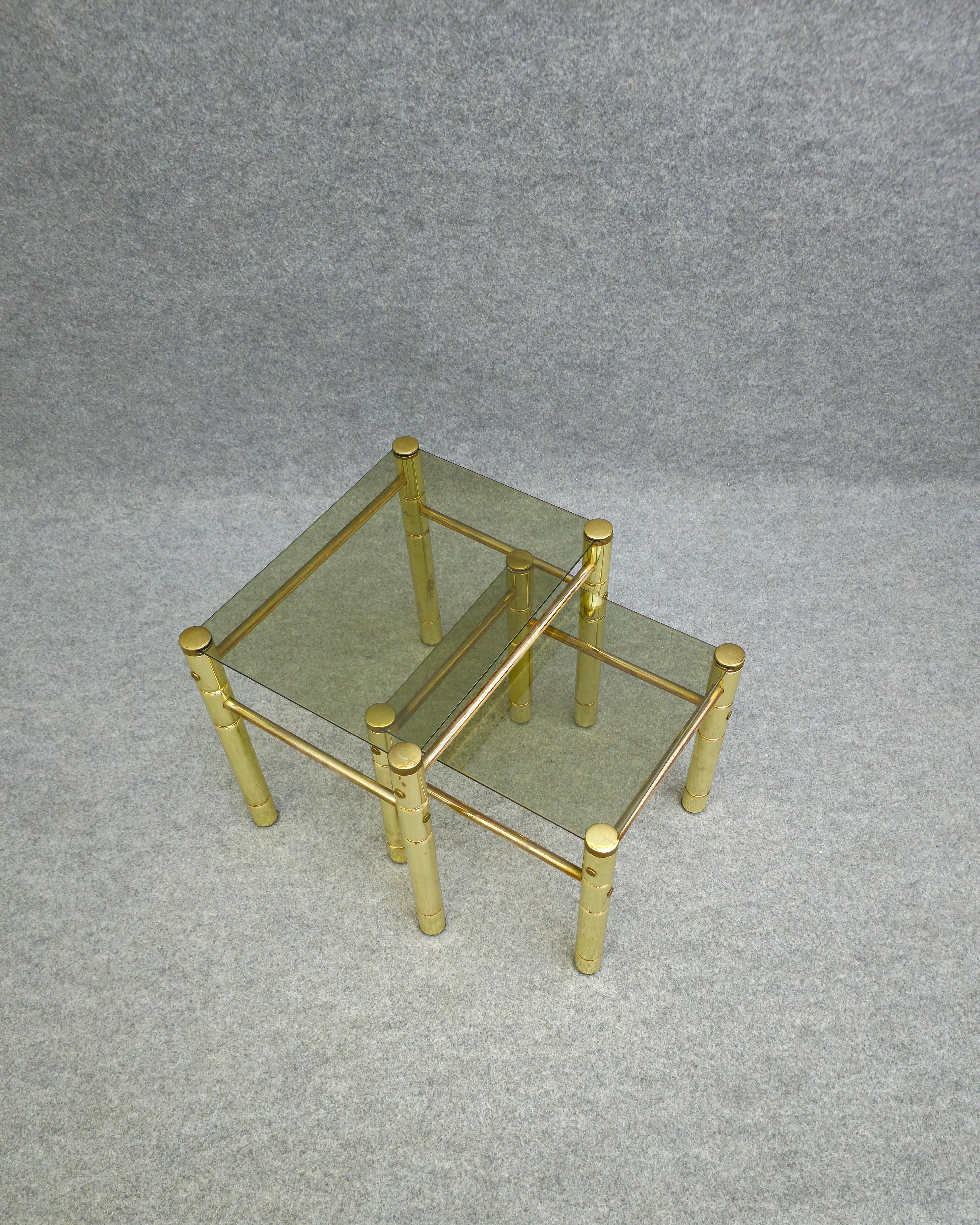 Midcentury brass,metal gilg and glass  set of 2 nesting tables. Modernist faux bamboo styled nesting tables. Perfectly functionable. 
One rectangular, one square. Smoked glass. Please watch the video and photos carefully, thank you.


Measures: