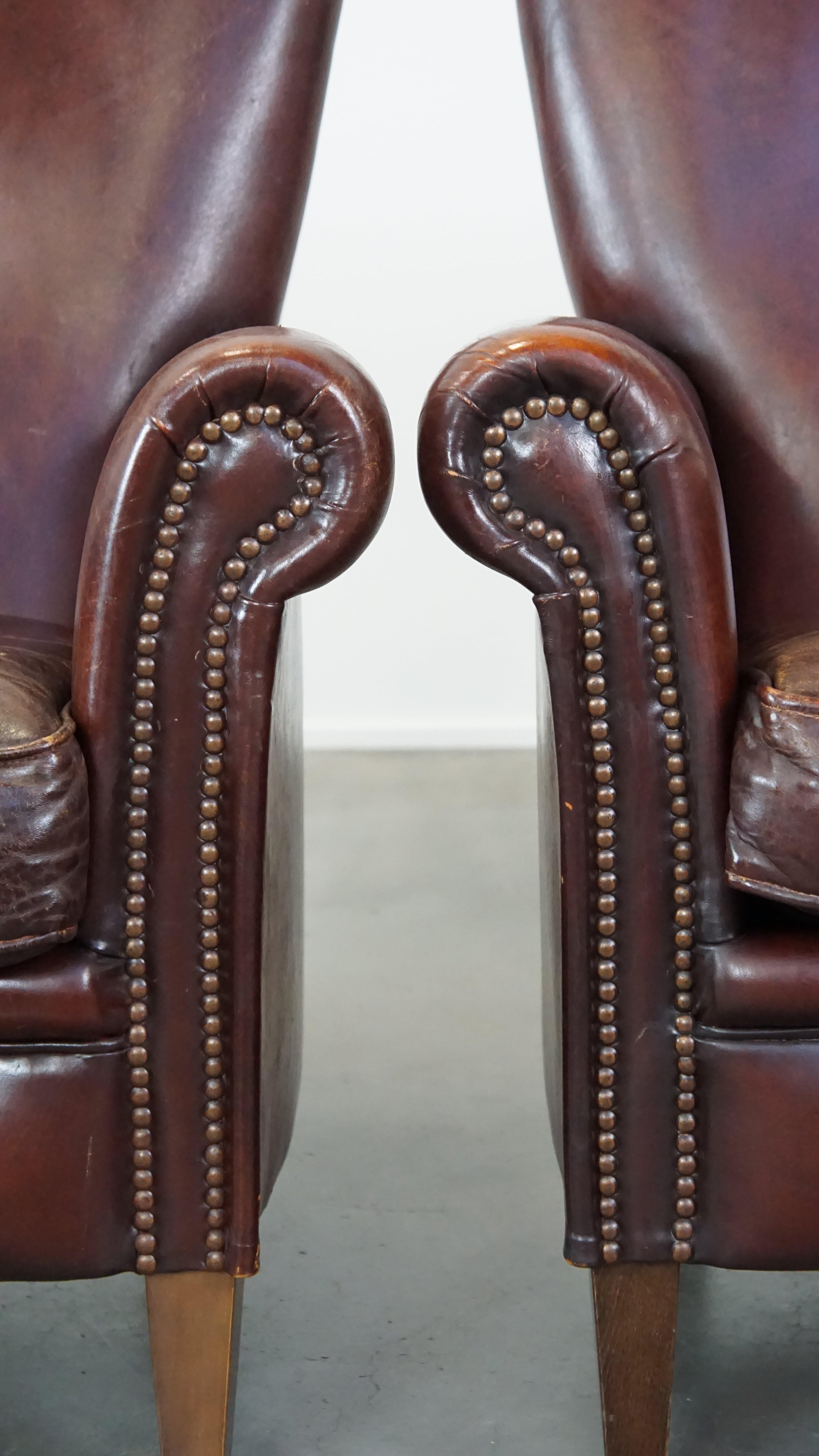 Set of 2 stately sheepskin armchairs with proper finishing with decorative nails For Sale 7