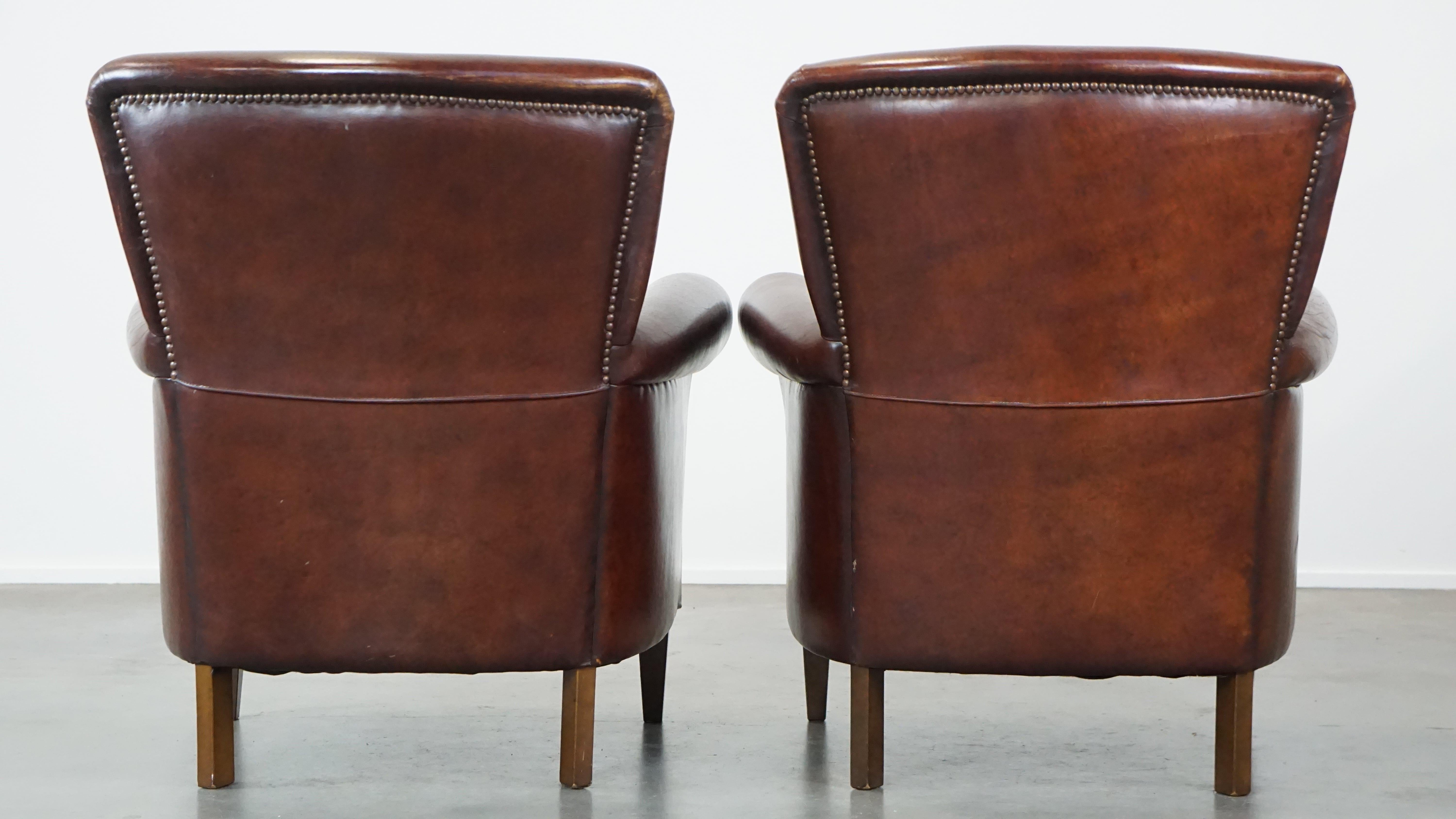 Hand-Crafted Set of 2 stately sheepskin armchairs with proper finishing with decorative nails For Sale