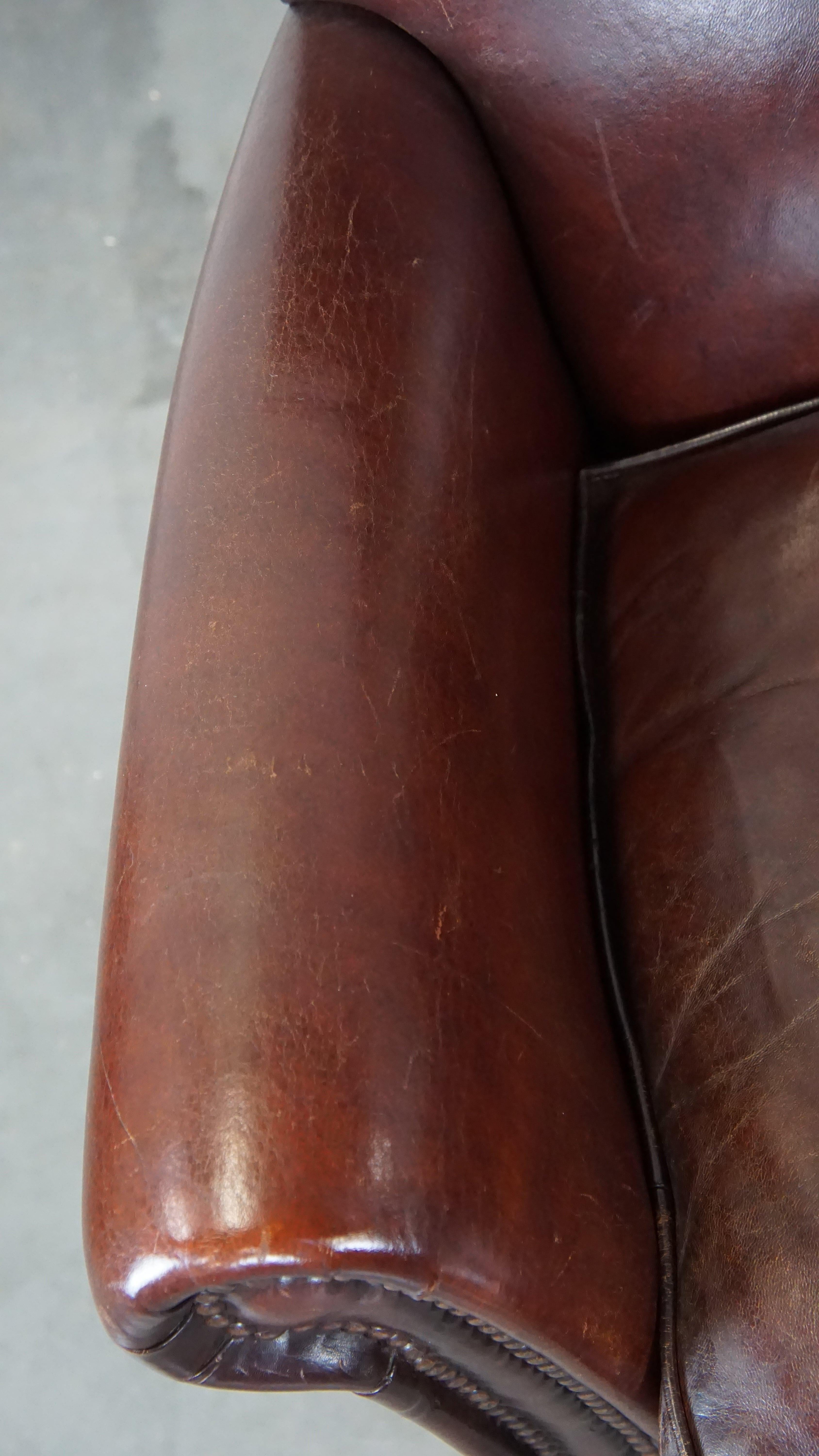 Set of 2 stately sheepskin armchairs with proper finishing with decorative nails For Sale 1
