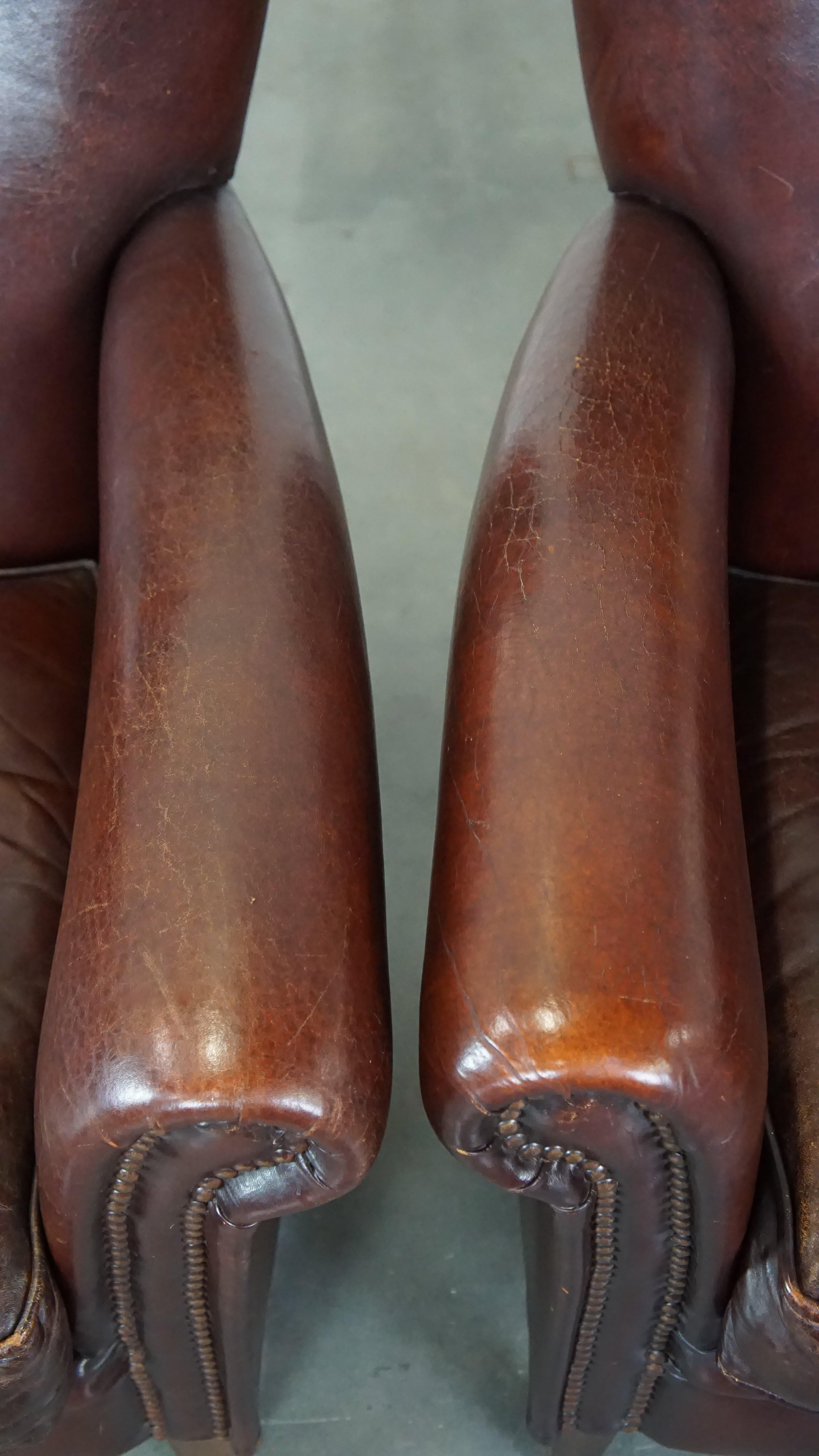 Set of 2 stately sheepskin armchairs with proper finishing with decorative nails For Sale 2