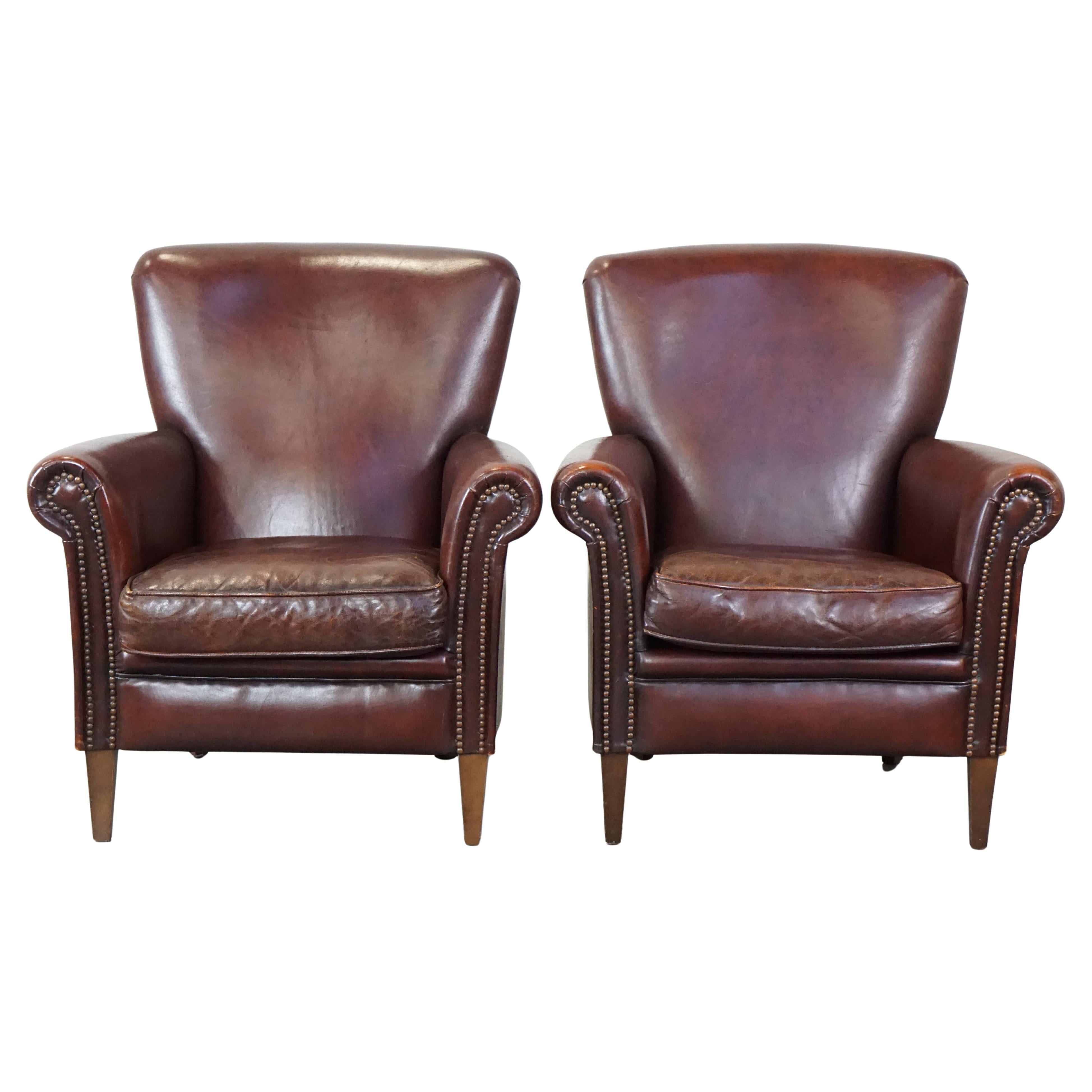 Set of 2 stately sheepskin armchairs with proper finishing with decorative nails For Sale