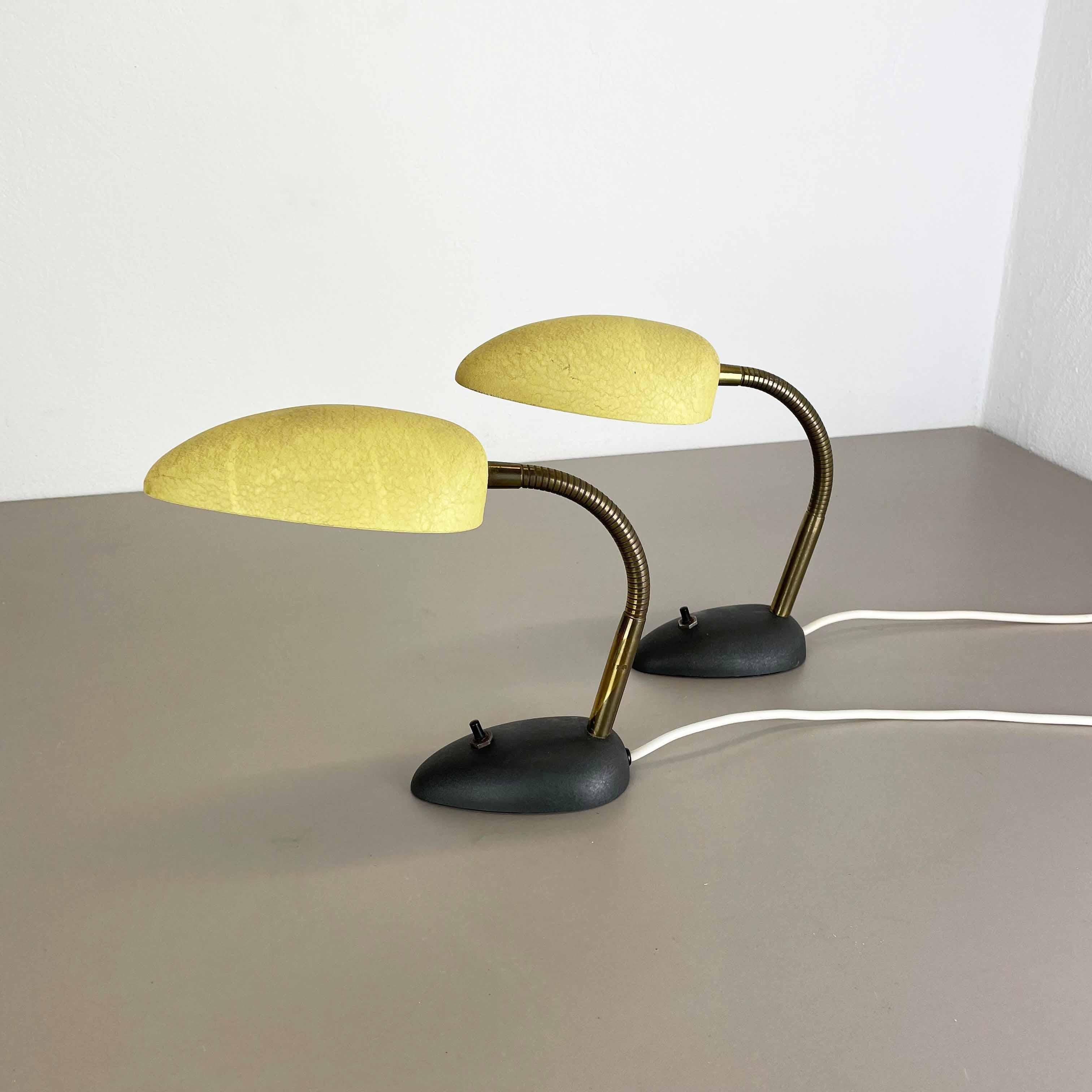 Article:

Modernist brass table light set of 2


Origin:

Italy


Decade:

1950s





This original vintage light set was designed and produced in the 1950s in Italy. The light is made of metal with a shade in yellow and stand base
