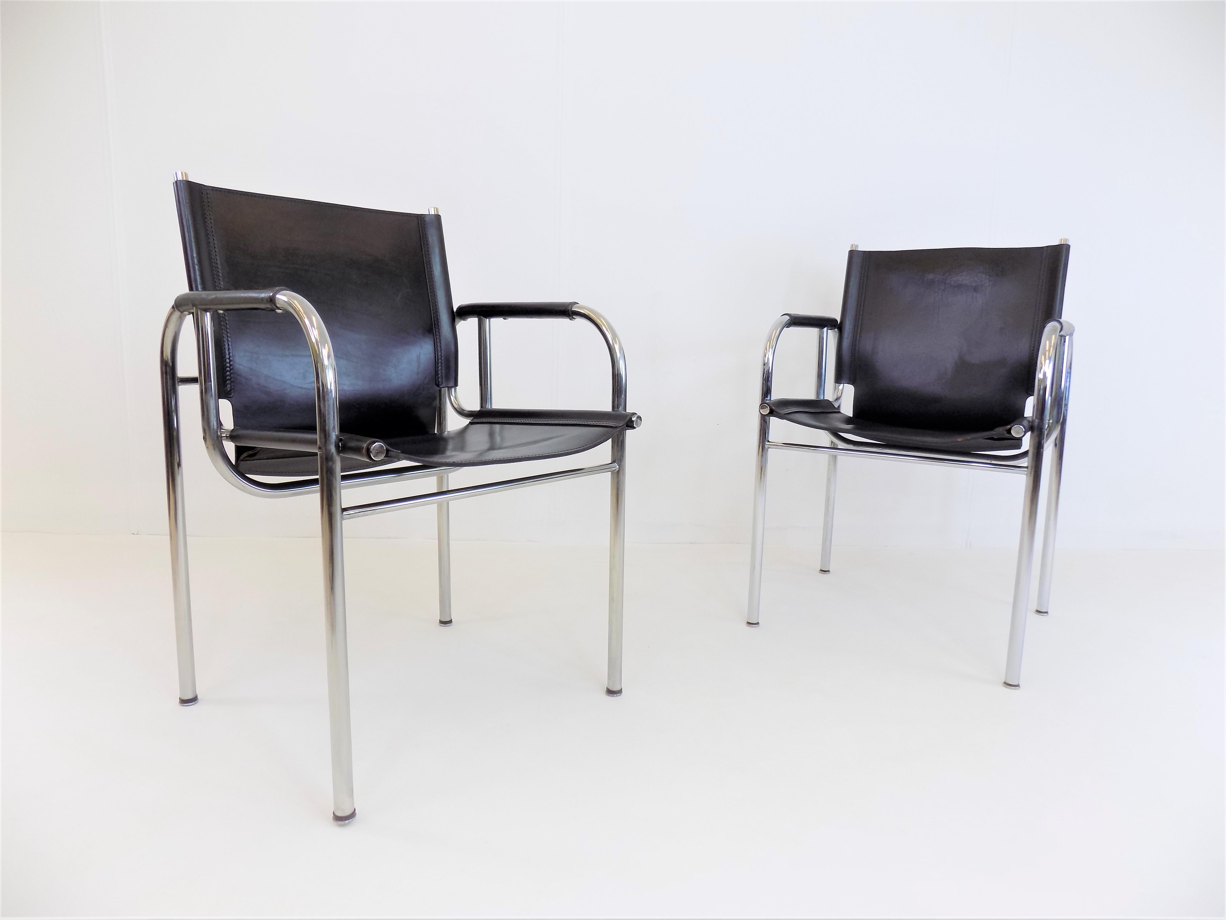 First class Strässle leather lounge chair from the 1960s. The lounge chairs, in a deep black leather tone, come in very good condition. The leather shows minimal signs of wear, Patina on the backrest of a chair. The chrome frames are in excellent