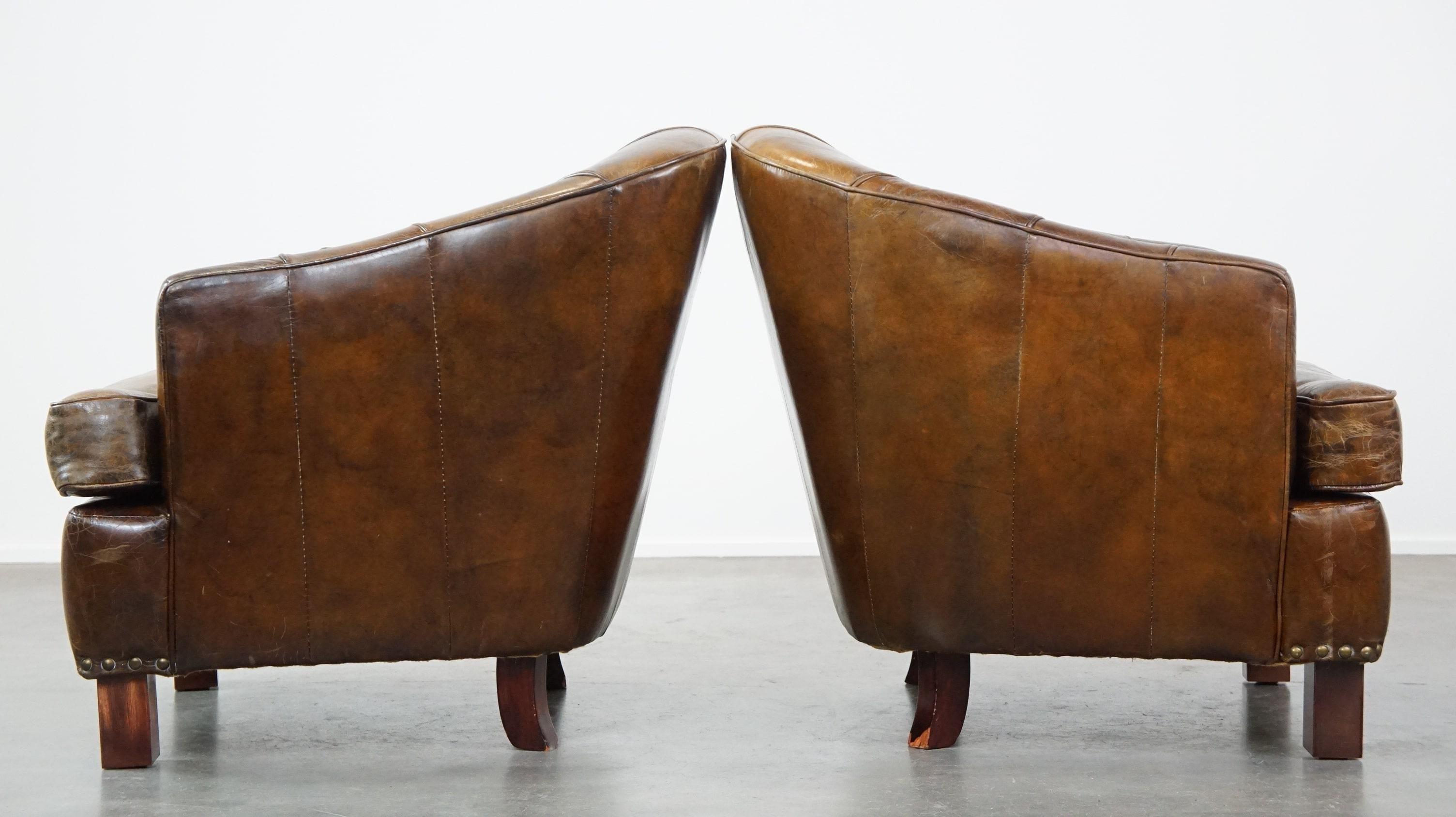 Hand-Crafted Set of 2 sturdy design armchairs made of cowhide with a beautiful deep color For Sale
