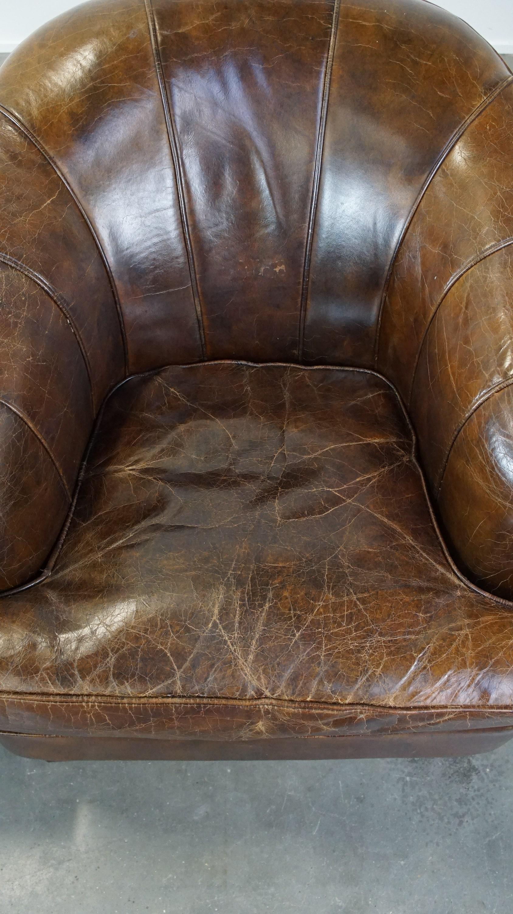 20th Century Set of 2 sturdy design armchairs made of cowhide with a beautiful deep color For Sale