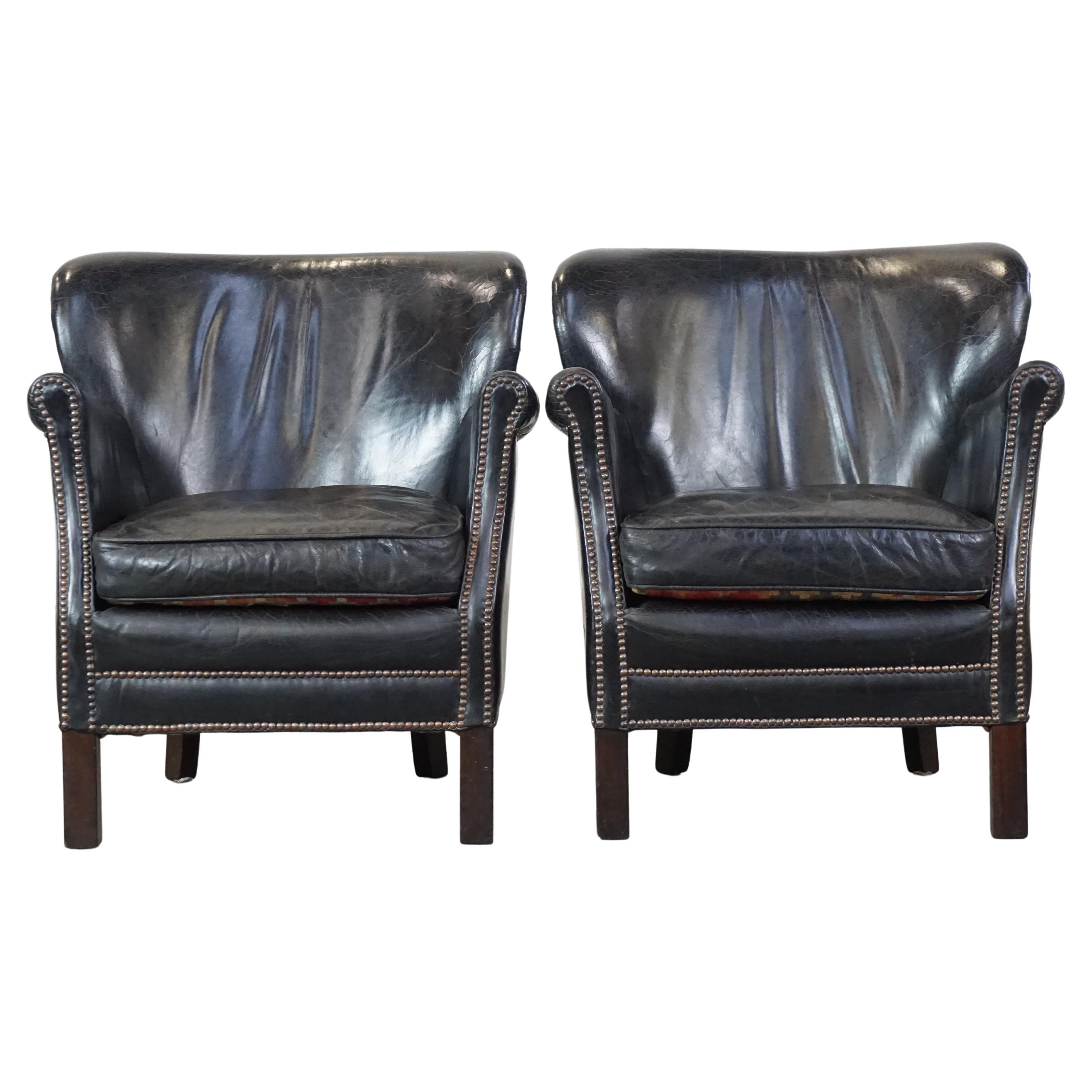 Set of 2 subtle black armchairs in English style with reversible Kelim cushions