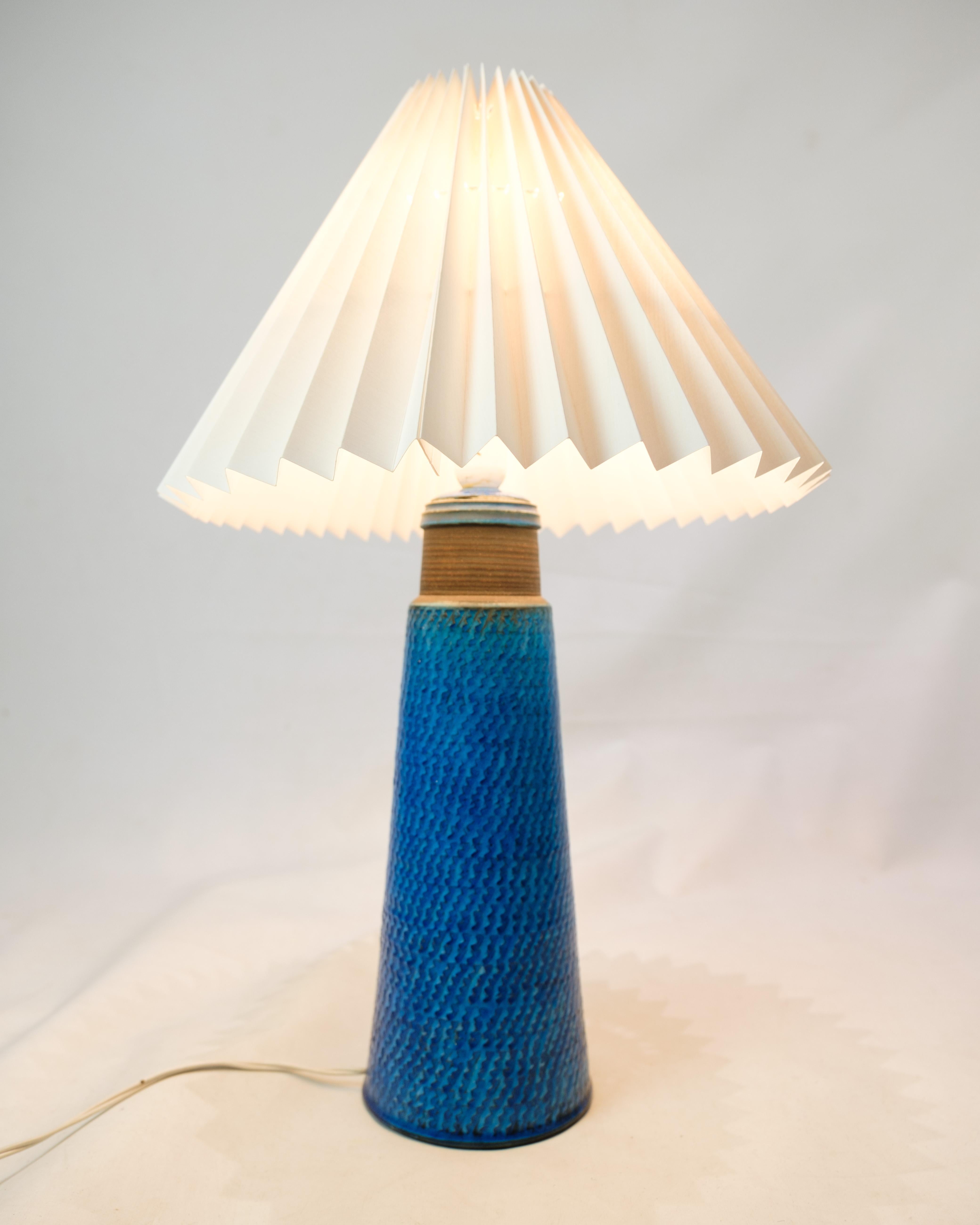 This set of two table lamps are unique examples of design beauty, created by Nils Kähler and produced by Herman A. Kähler. The lamp's blue color and herringbone pattern give an unmistakable and charming expression that creates a unique atmosphere in