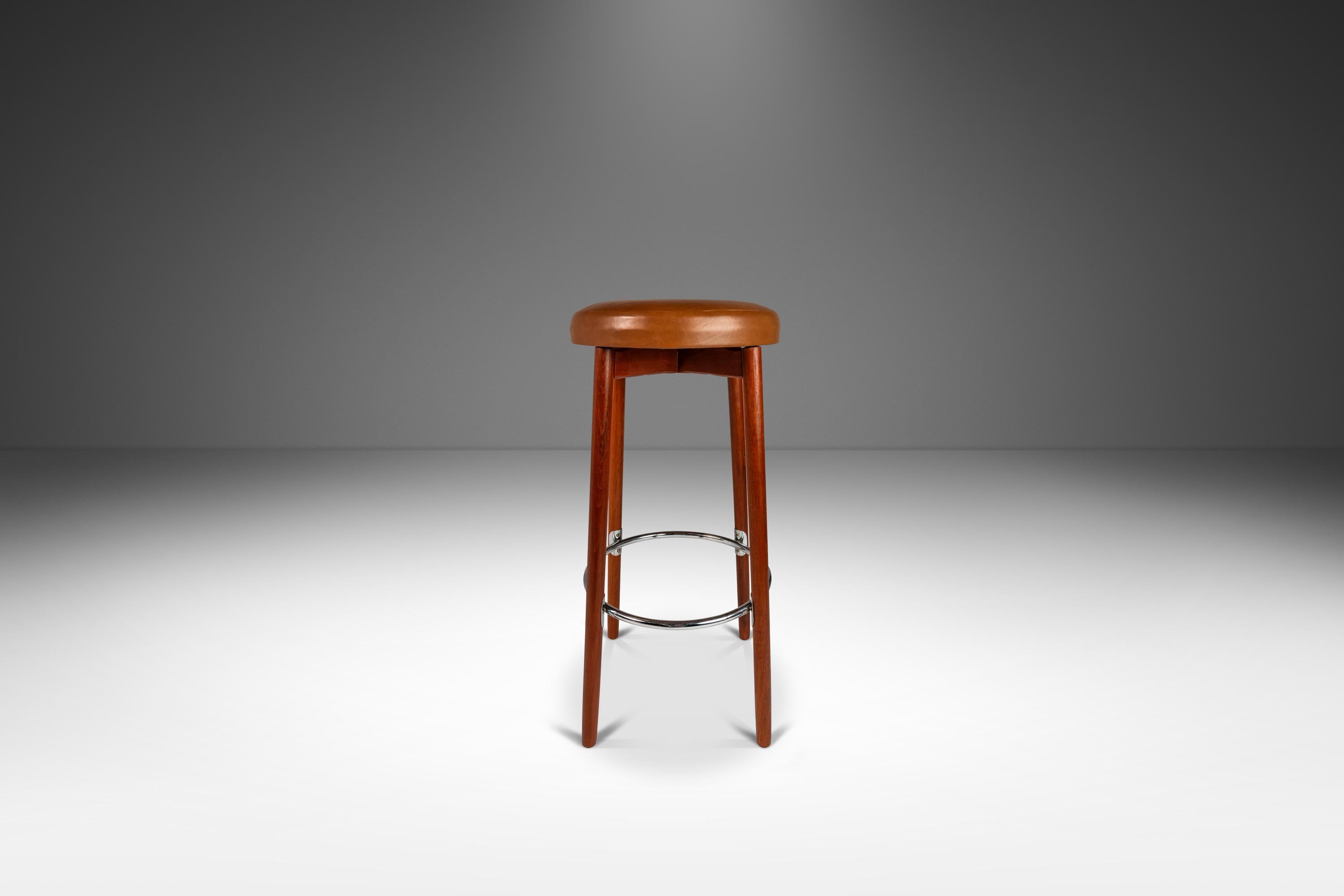Introducing a rare set of Danish Modern barstools designed by the influential Hugo Frandsen for Spøttrup Mobler. Save for the newly re-upholstered seats these visually stunning stools are in original, vintage condition and have aged to