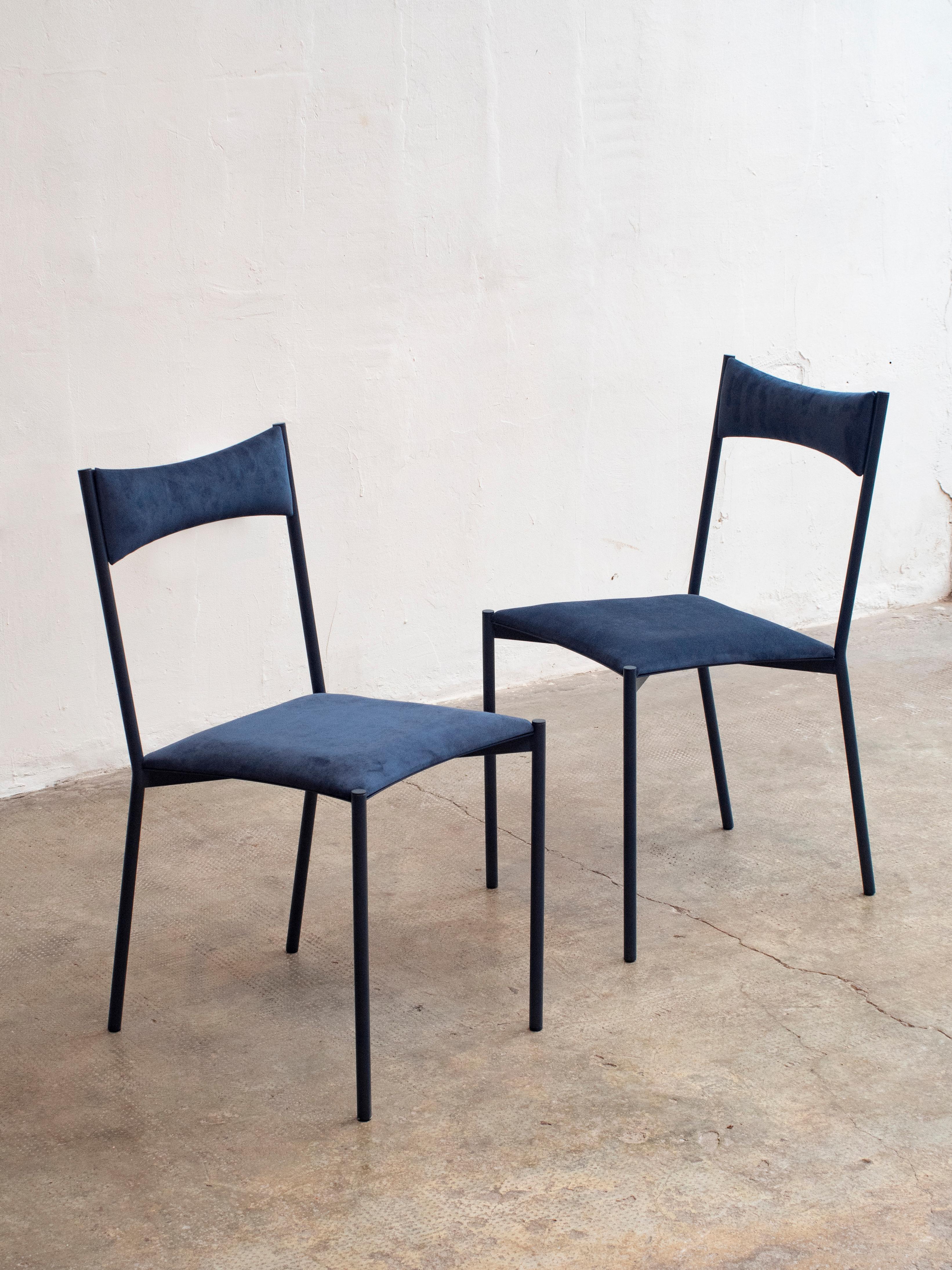 A set of 2 tensa chairs, dark blue by Ries
Dimensions: W 40 x D 49.5 x H 82 cm 
Materials: Round steel tube, laser cut metal sheet, high density foam, velvet upholstery, aluminum/bronze caps
Matte powder coated painting (Finishings)

Also