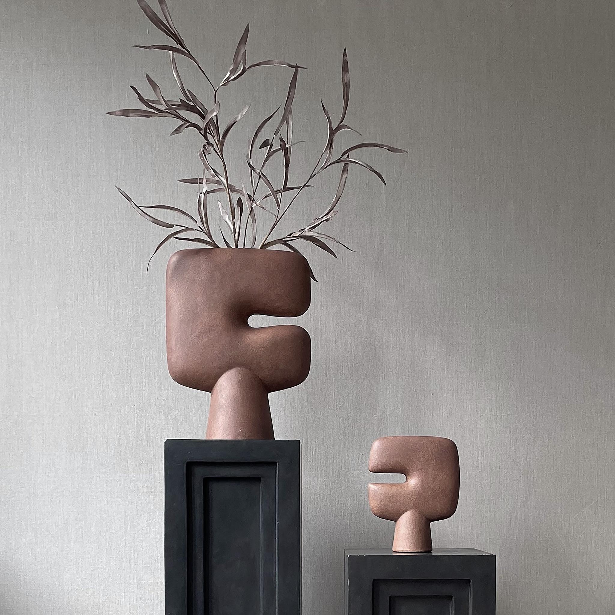 A Set of 2 terracotta tribal vase medio by 101 Copenhagen
Designed by Kristian Sofus Hansen & Tommy Hyldahl
Dimensions: L24 / W10 / H30 CM
Materials: Ceramic

The Tribal collection is a series of vases designed as a sculptural take on the