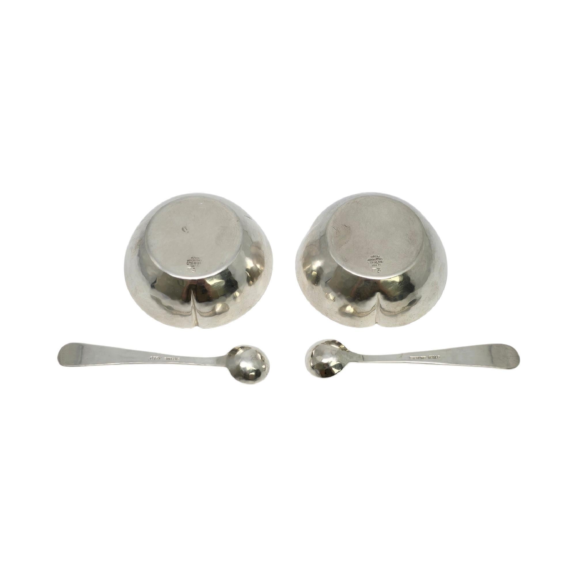 Set of 2 hammered sterling silver salt cellars and spoon sets by The Kalo Shop.

No monogram

The Kalo Shop began producing handwrought objects in Chicago in 1900. These 2 salt cellars and 2 spoons feature a slightly hammered finish. The cellars are