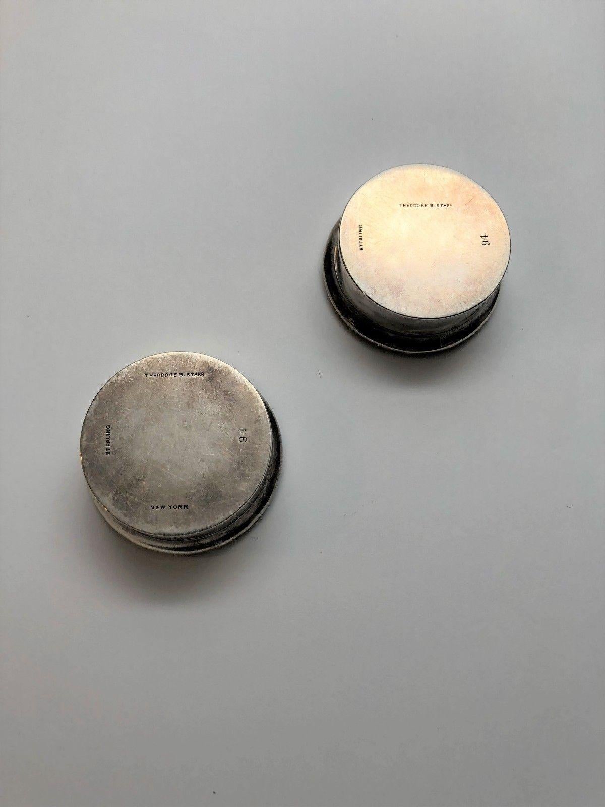 Set of 2 sterling silver repoussé round pill box by Theodore B Starr. Starr was in business from 1862-1923. Monogrammed MEH. Marked: STERLING THEODORE B STARR NEW YORK (on one box) 94. Measures: lid is approx 1 7/8