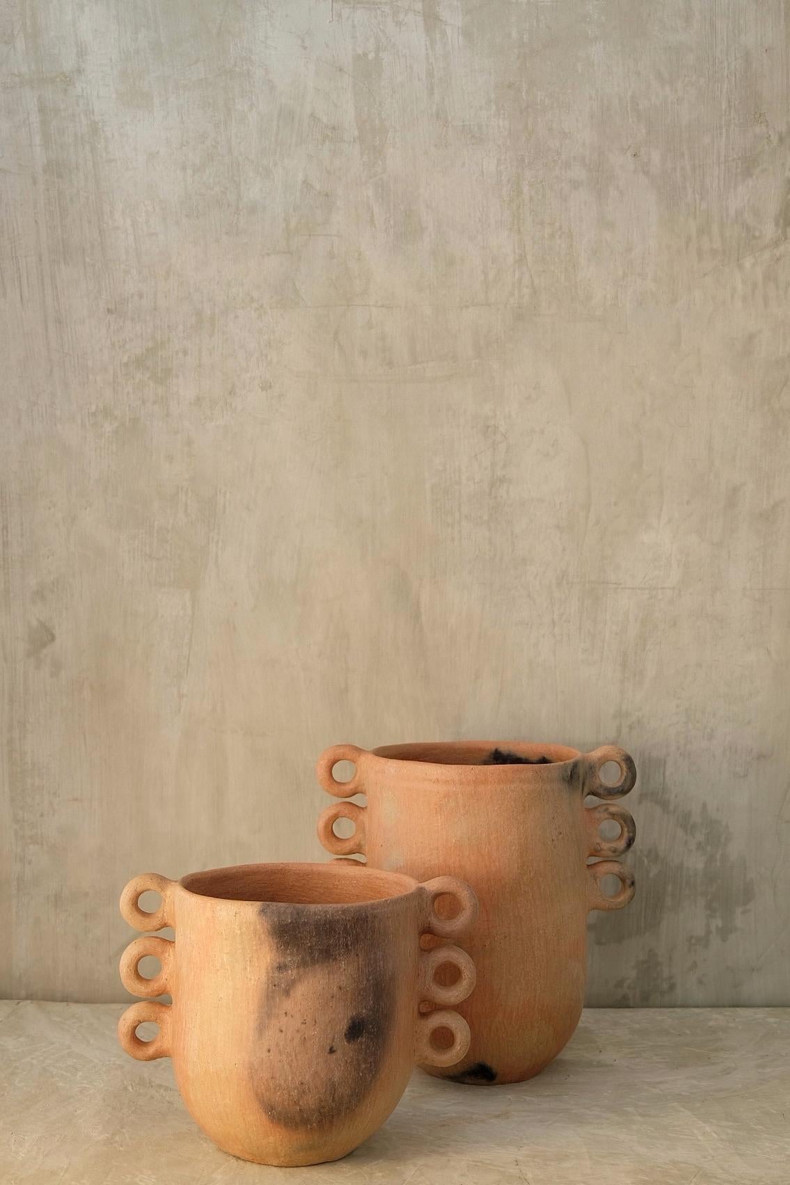 Tierra Caliente vase by Onora
Dimensions: 
D 20 x H 30 cm
D 20 x H 20 cm 
Materials: Clay

Hand sculpted clay, covered with a mineral based slip and burnished using a quartz stone. 

We are a Mexican brand dedicated to the creation of high