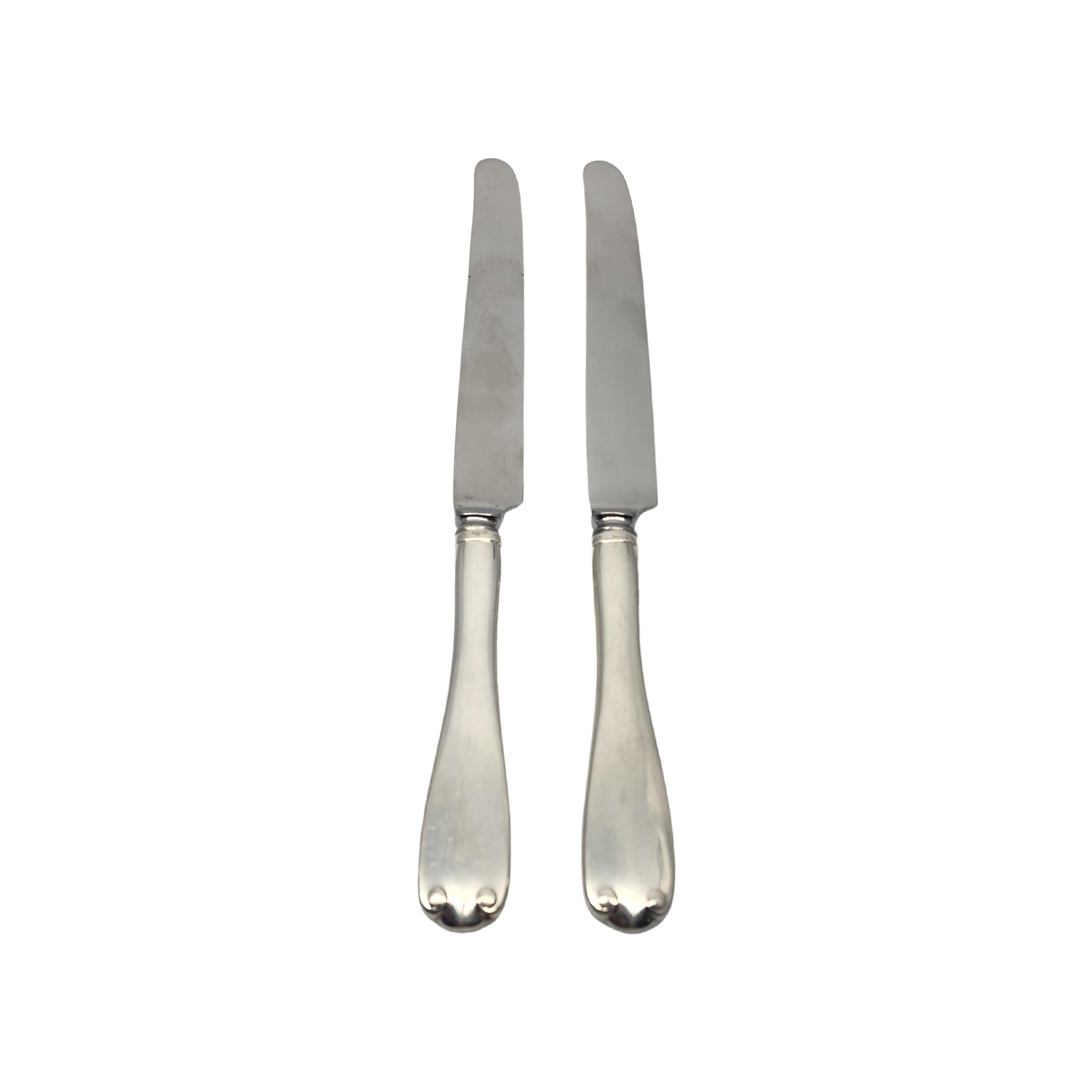 Set of 2 sterling silver handle stainless blade knives by Tiffany & Co in the Flemish pattern.

No monogram.

The Flemish pattern features a simple and elegant scroll design, making it a timeless classic that is still in demand today. Does not