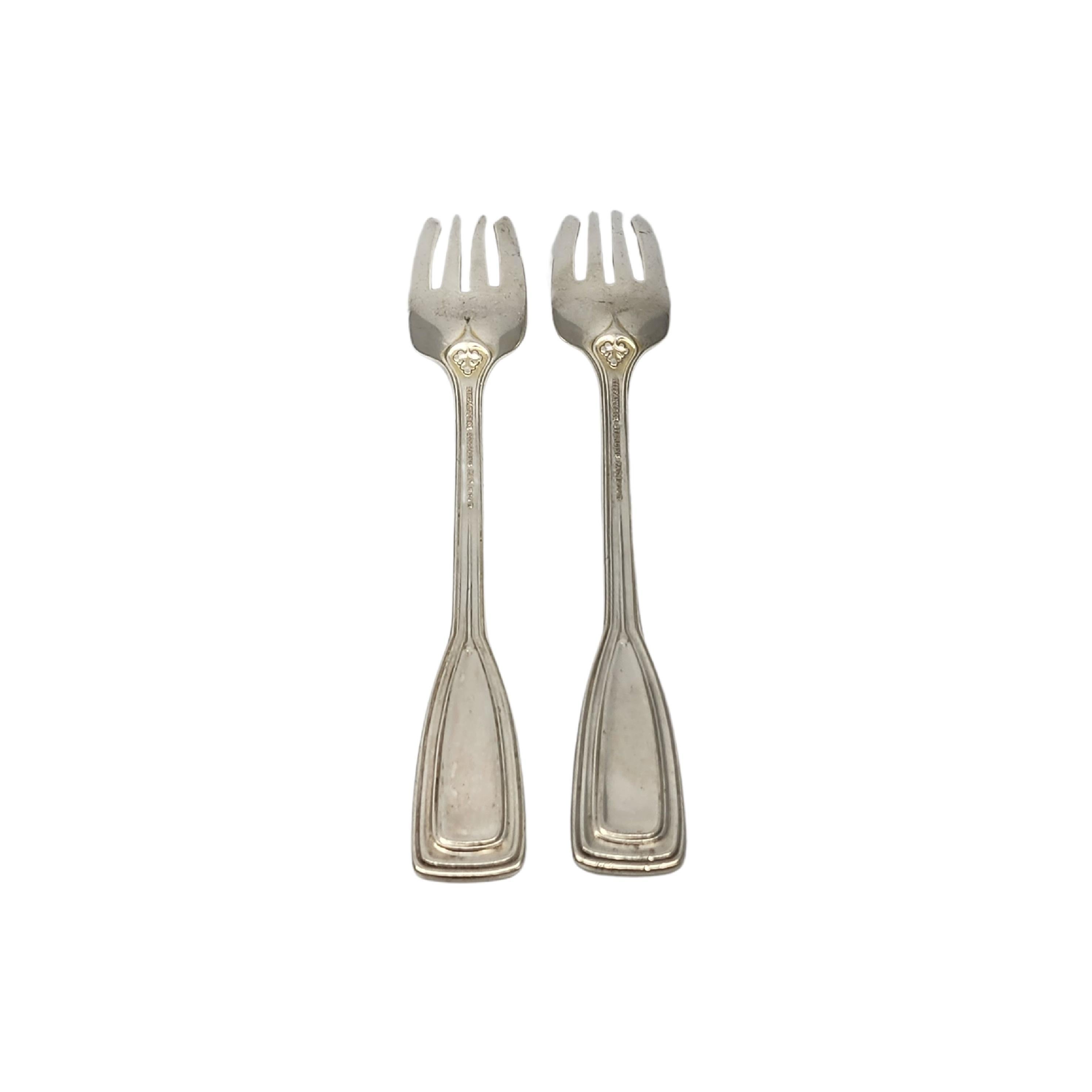 Set of 2 sterling silver salad forks by Tiffany & Co in the St. Dunstan pattern with monogram.

Monogram appears to be W

Designed by Albert A. Southwick in 1909 and named for the patron saint of gold and silversmiths, Tiffany's St. Dunstan pattern