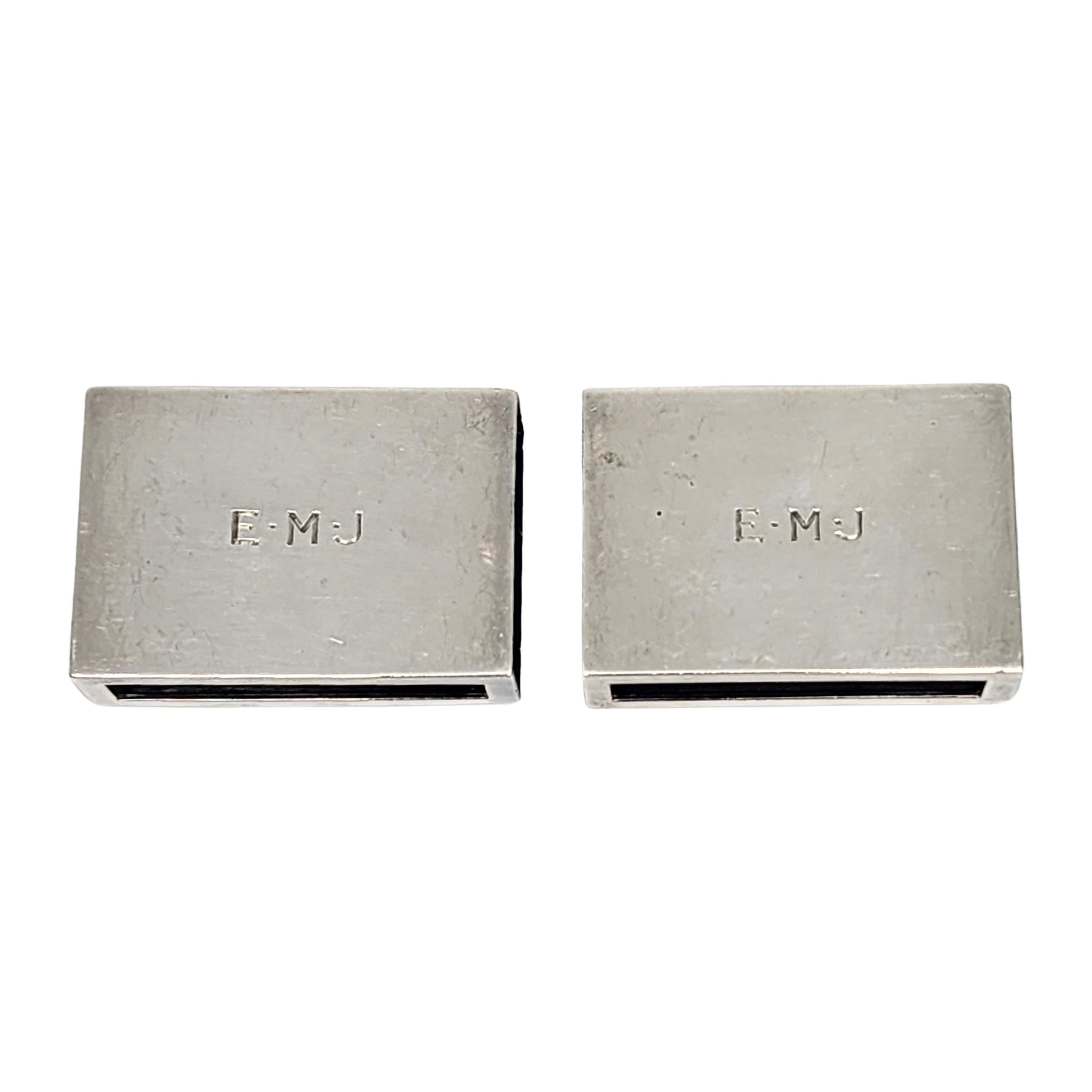 Set of 2 Tiffany & Co sterling silver matchbox covers with monogram, circa 1936.

Monogram appears to be EMJ

A simple and timeless design, with a smooth polished finish. The M hallmark on the ashtrays date this piece to manufacture under the