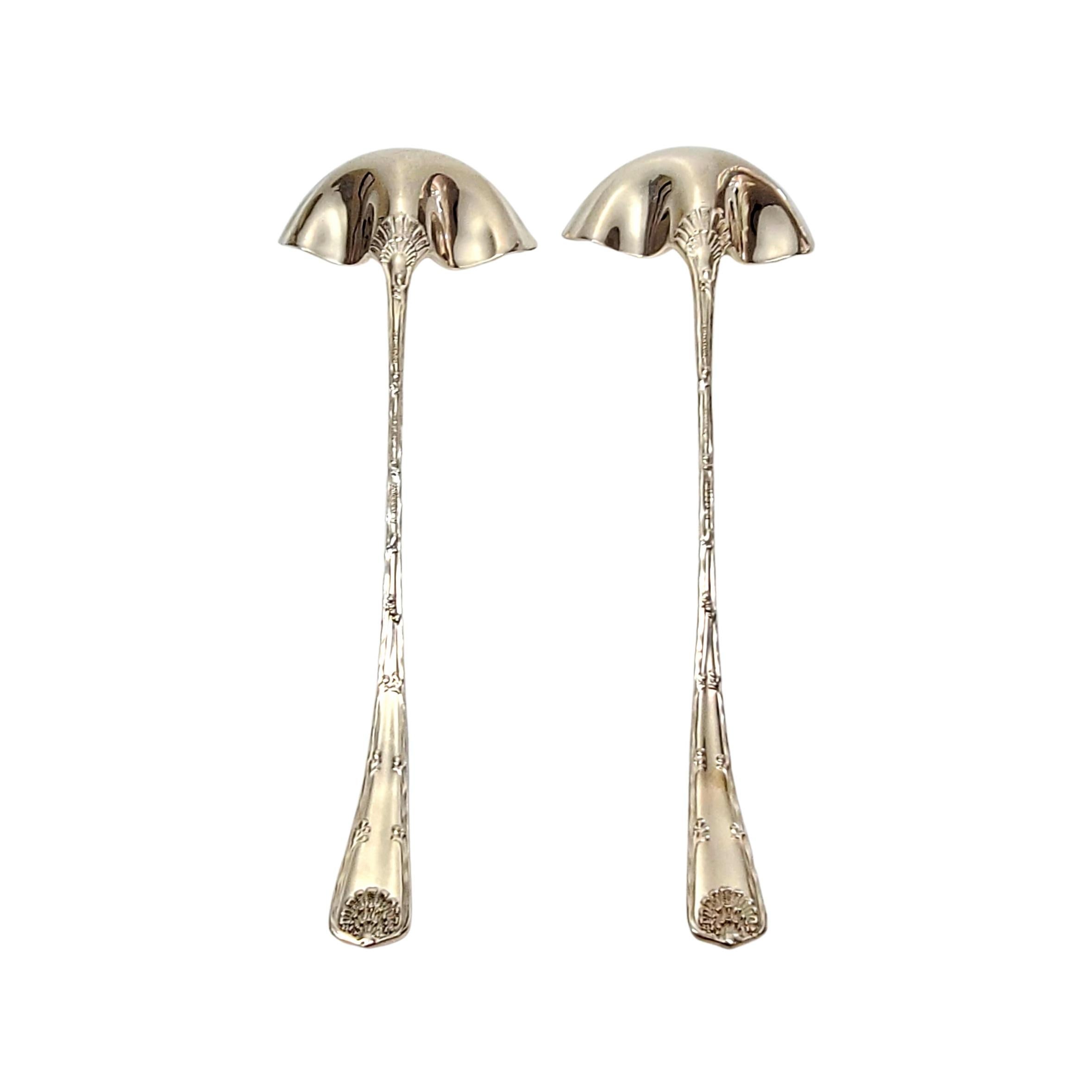 Set of 2 sterling silver cream ladles by Tiffany & Co in the Wave Edge pattern.

No monogram.

The Wave Edge pattern is a marine motif designed by Charles T. Grosjean in 1884. The ladles feature a shell design at the op of each handle. Hallmarks