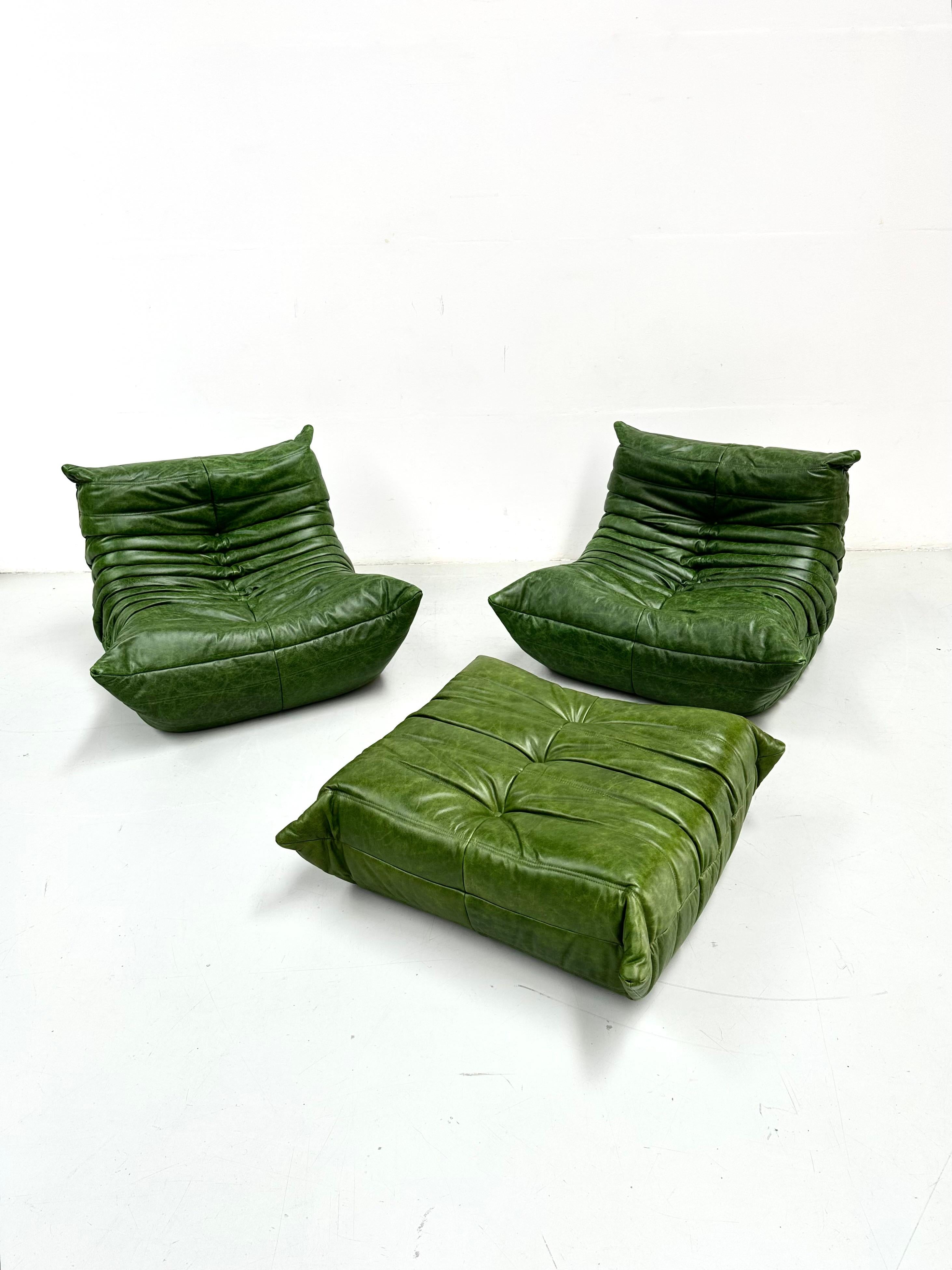 Mid-Century Modern Set of 2 Togo Chairs and Ottoman in Green Leather by M. Ducaroy for Ligne Roset.