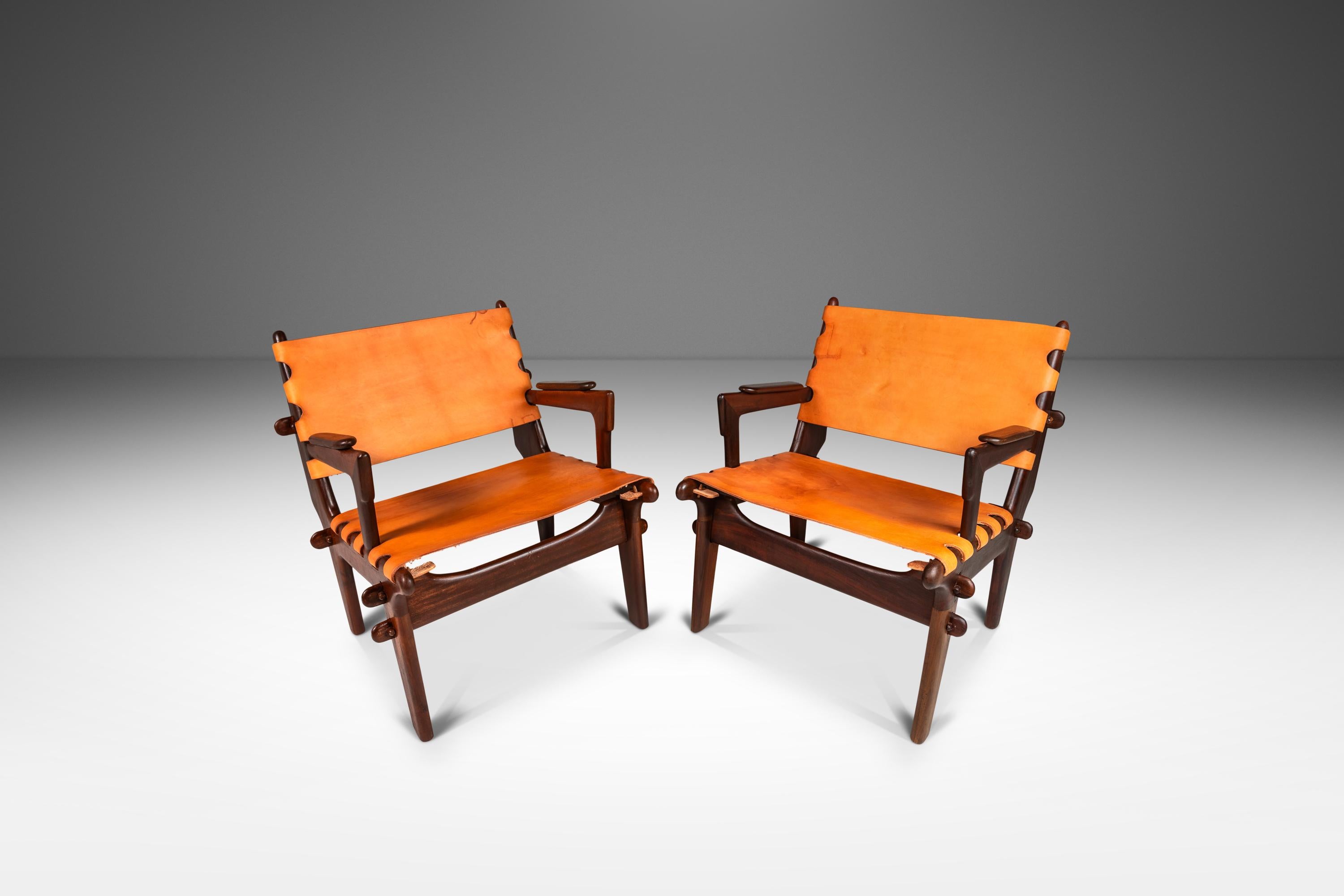  Introducing a rare set of sling chairs by the incomparable Angel Pazmino. Recently and painstakingly restored by our team of craftsmen this iconic set has a new lease on life and we love the results. The solid jacaranda wood frames have been