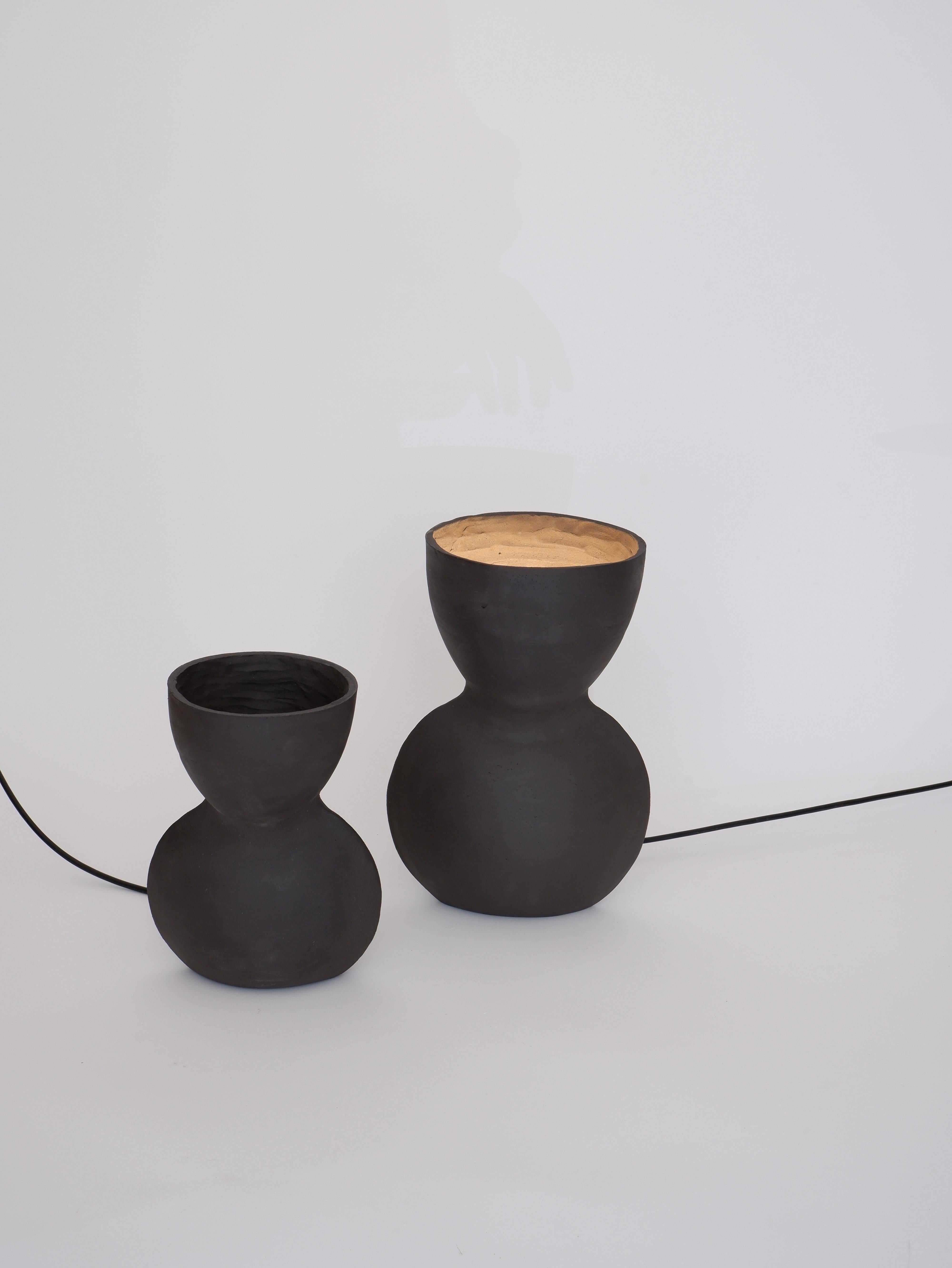 Set Of 2 Unira Black Lamps by Ia Kutateladze
One Of A Kind.
Dimensions: Small: D 14 x W 18 x H 25 cm.
Big: D 17 x W 23 x H 32 cm. 
Materials: Clay.

Each piece is one of a kind, due to its free hand-building process. Different color variations