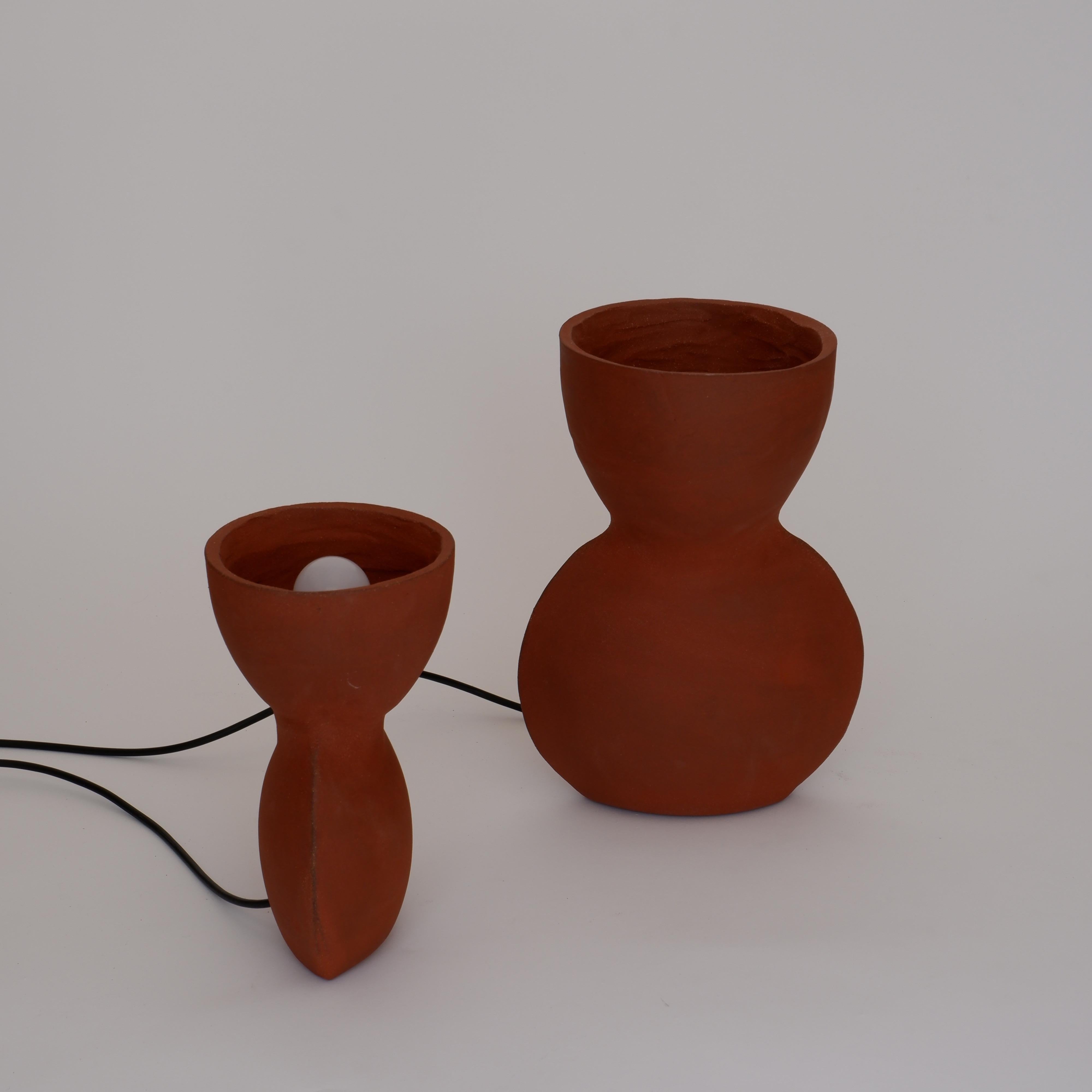Set Of 2 Unira Red Lamps by Ia Kutateladze
One Of A Kind.
Dimensions: Small: D 14 x W 18 x H 25 cm.
Big: D 17 x W 23 x H 32 cm. 
Materials: Clay.

Each piece is one of a kind, due to its free hand-building process. Different color variations