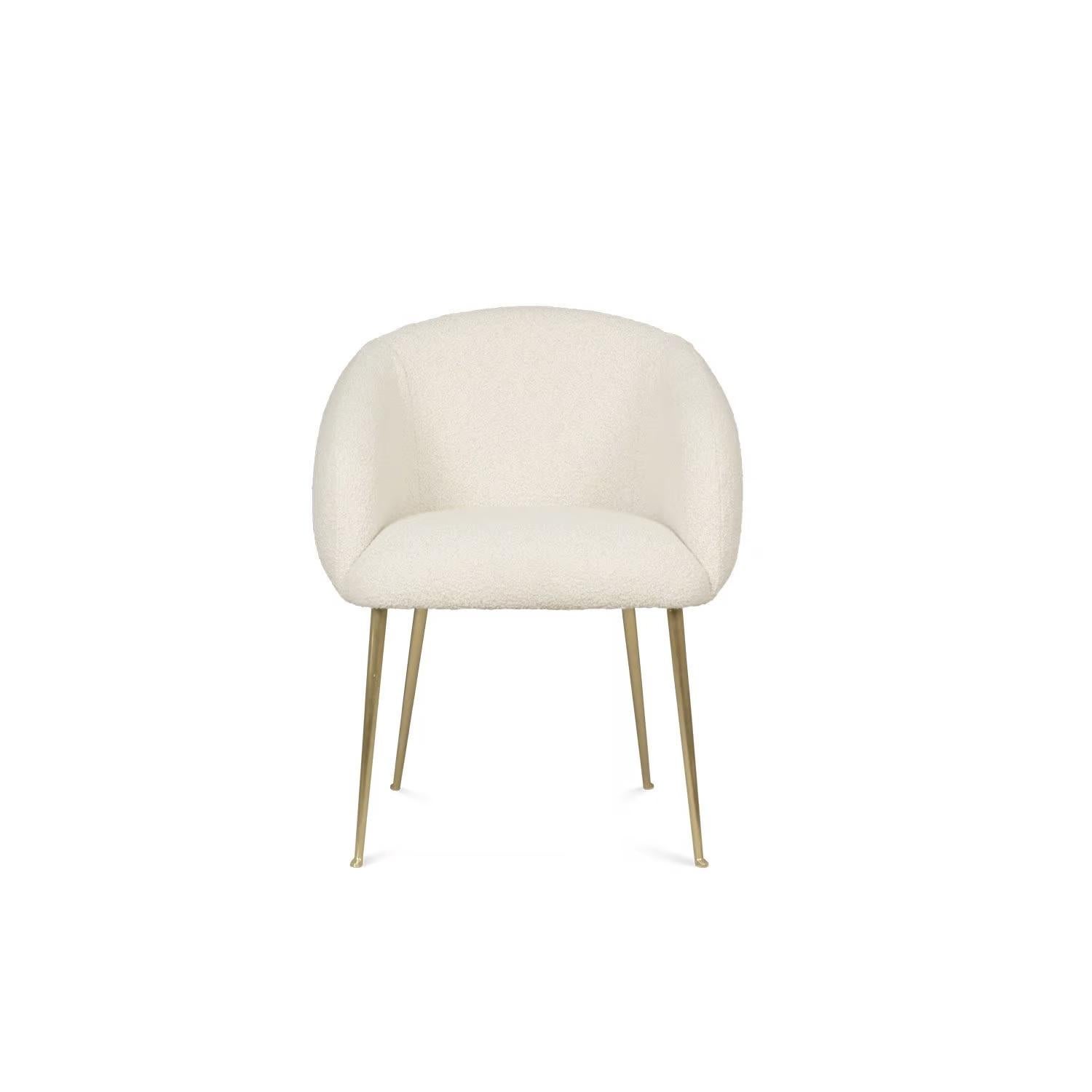 This chair is covered in boucle fabric, offering both comfort and style. Its sturdy brass legs provide a combination of strength and elegance to the overall design.
Dimensions: Width 24.4” x depth 17.75” x height 33.5” 
Custom sizes and materials