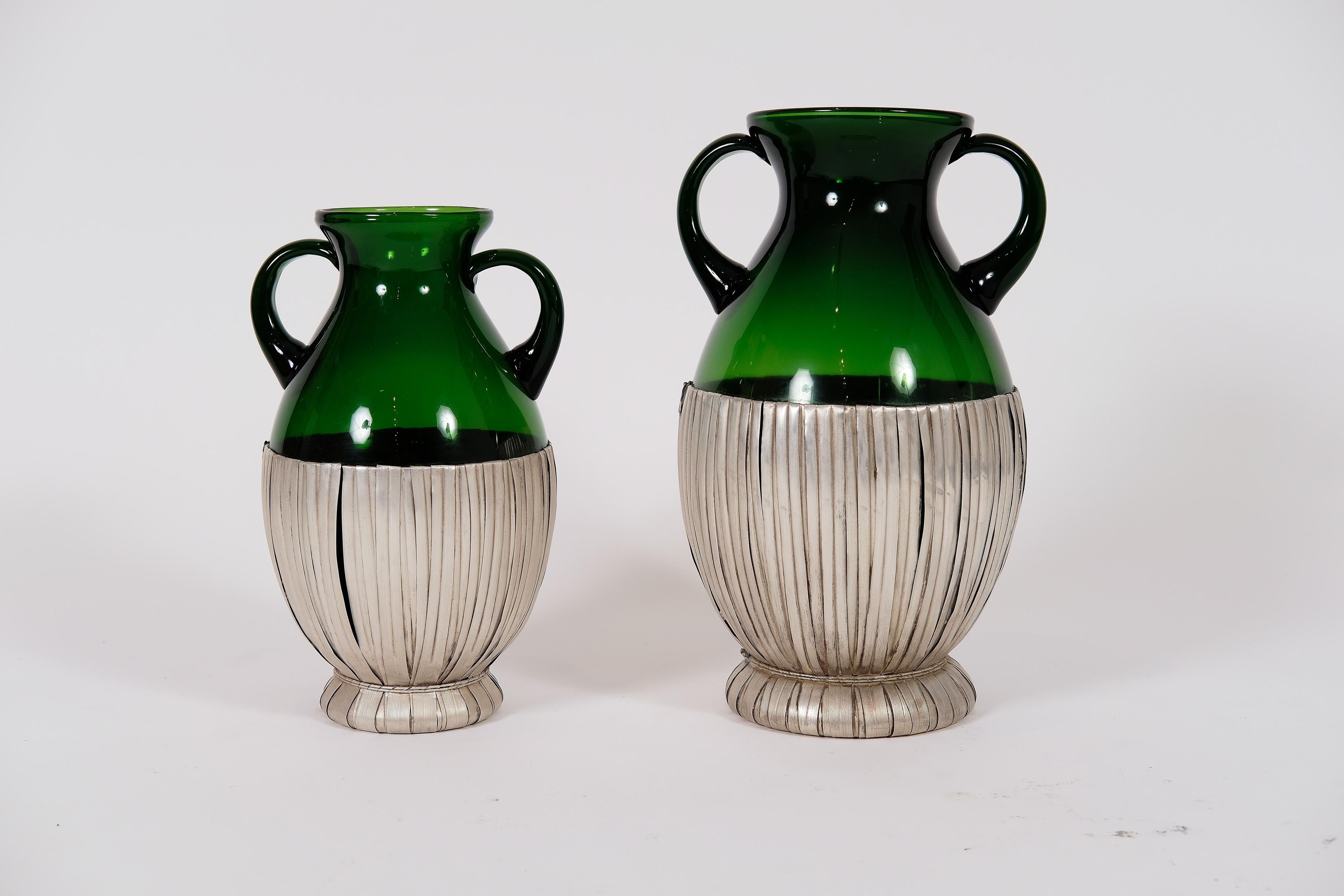 Set of two amphoras in green crystal, weaved in sterling silver by Italian master Giovanni Vavassori. Original seal on the side. 

The large one is 17 inches high with a diameter of 10.5 inches, and the smaller one is 14.5 inches high and 9 inches