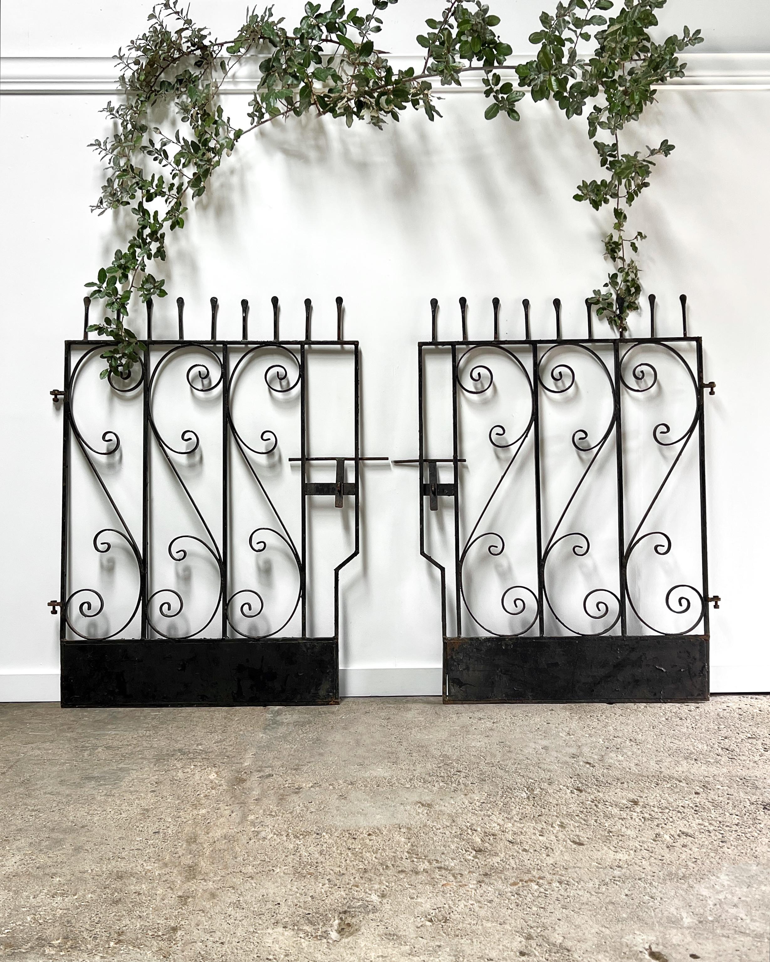 Sold as a set of two, these custom-made gates having great time-worn patina, were found in the English countryside, and salvaged from the same estate. Although they were originally used as individual gates, but with some creativity, they could be
