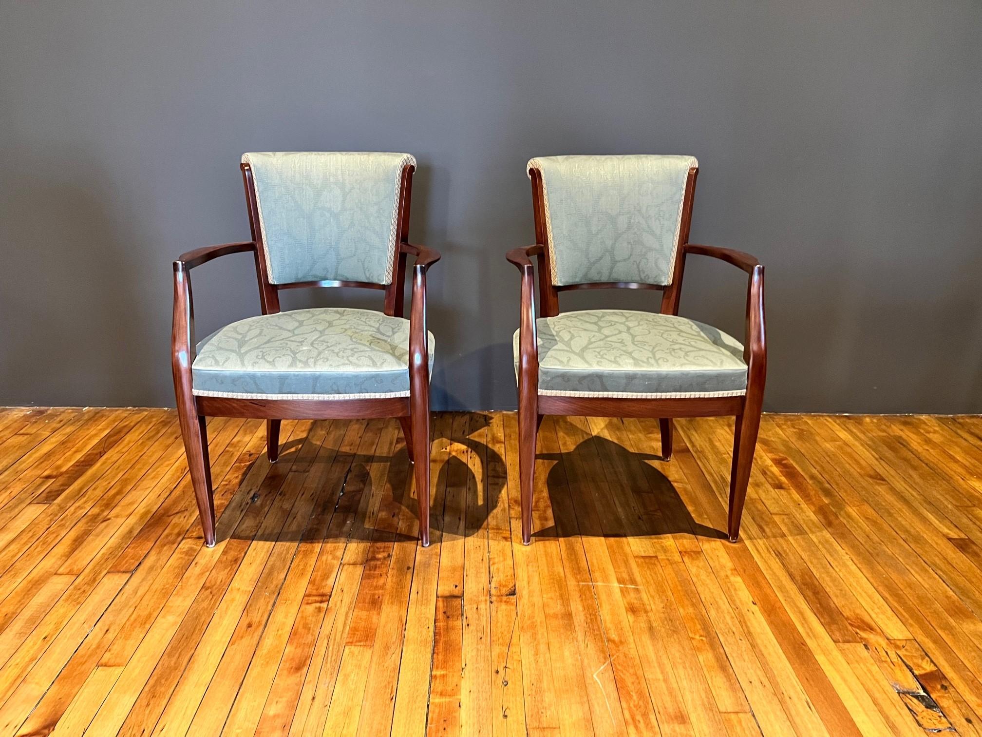 Elegant set of 2 Art Deco dining room armchairs in the style of Maurice Jallot, Jules Leleu and Jean Pascaud. The chairs boast solid wood frames with high backs and seats upholstered in green soft sheen jacquard fabric. 

8 matching dining room