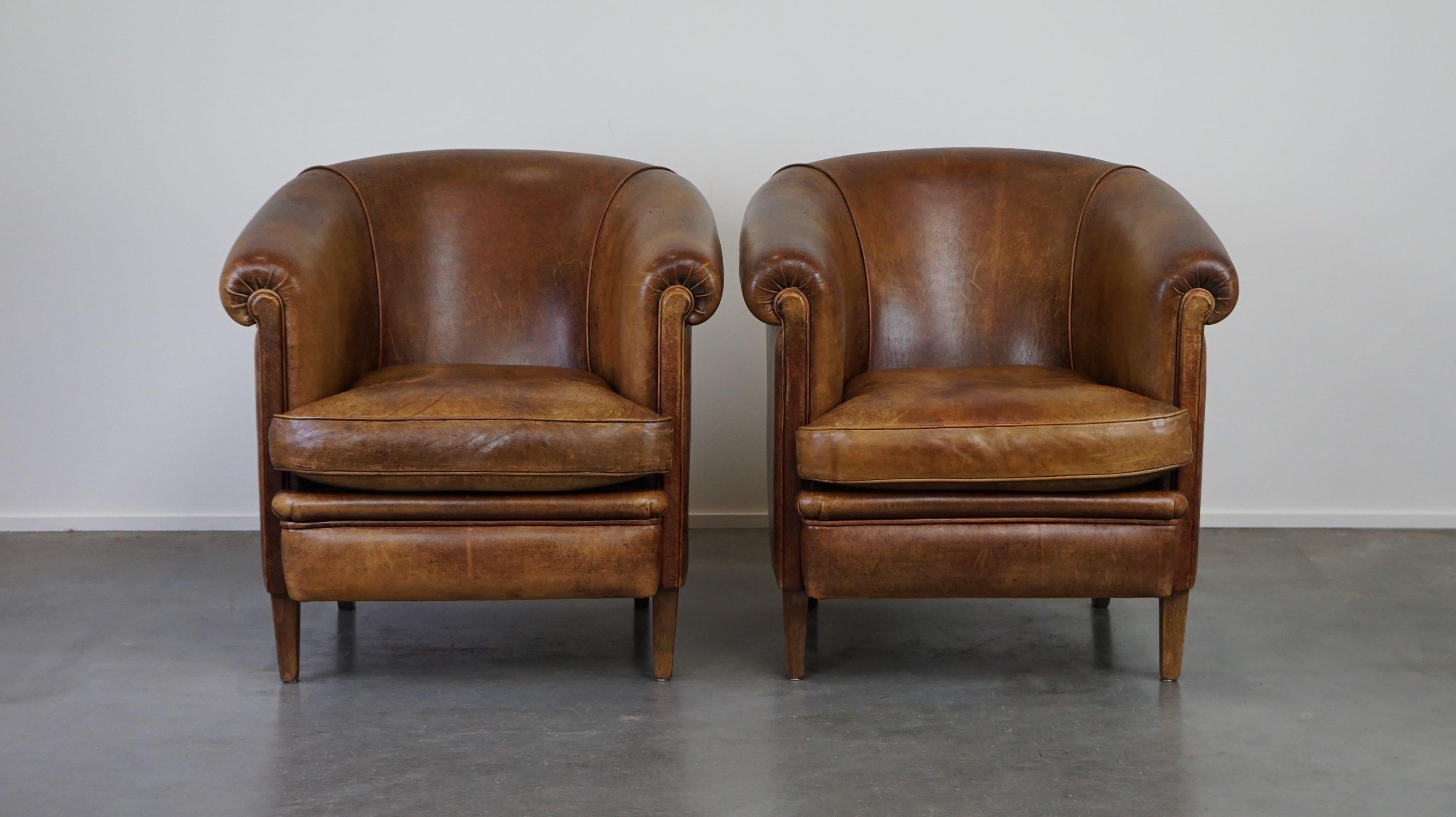 Offered: this super cute set of 2 vintage sheepskin club chairs with a beautiful worn look.

These timeless sheepskin club chairs have acquired a fantastic patina over the years, making them perfect for sitting in for hours. They feature loose seat