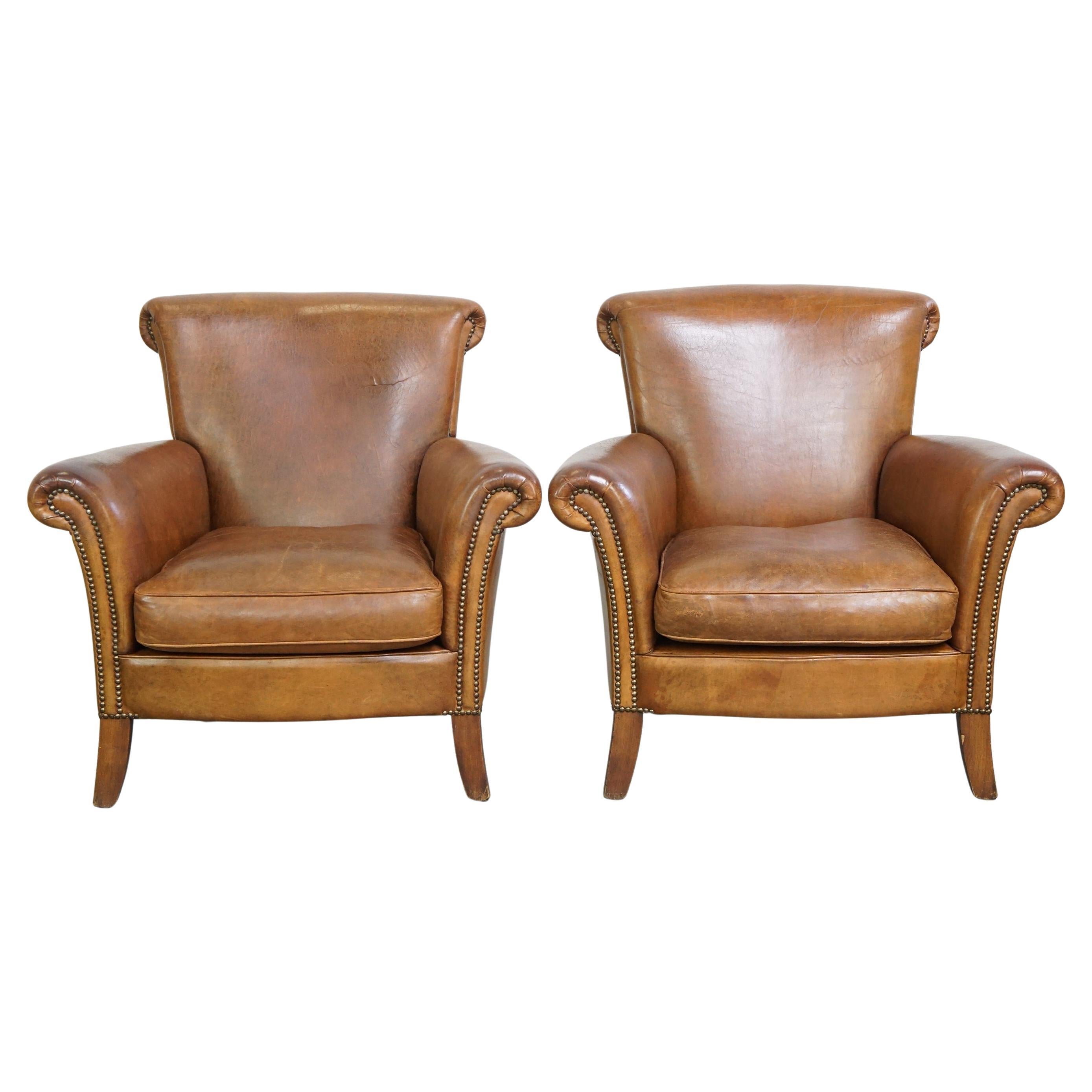 Set of 2 vintage sheepskin armchairs, finished with decorative nailheads
