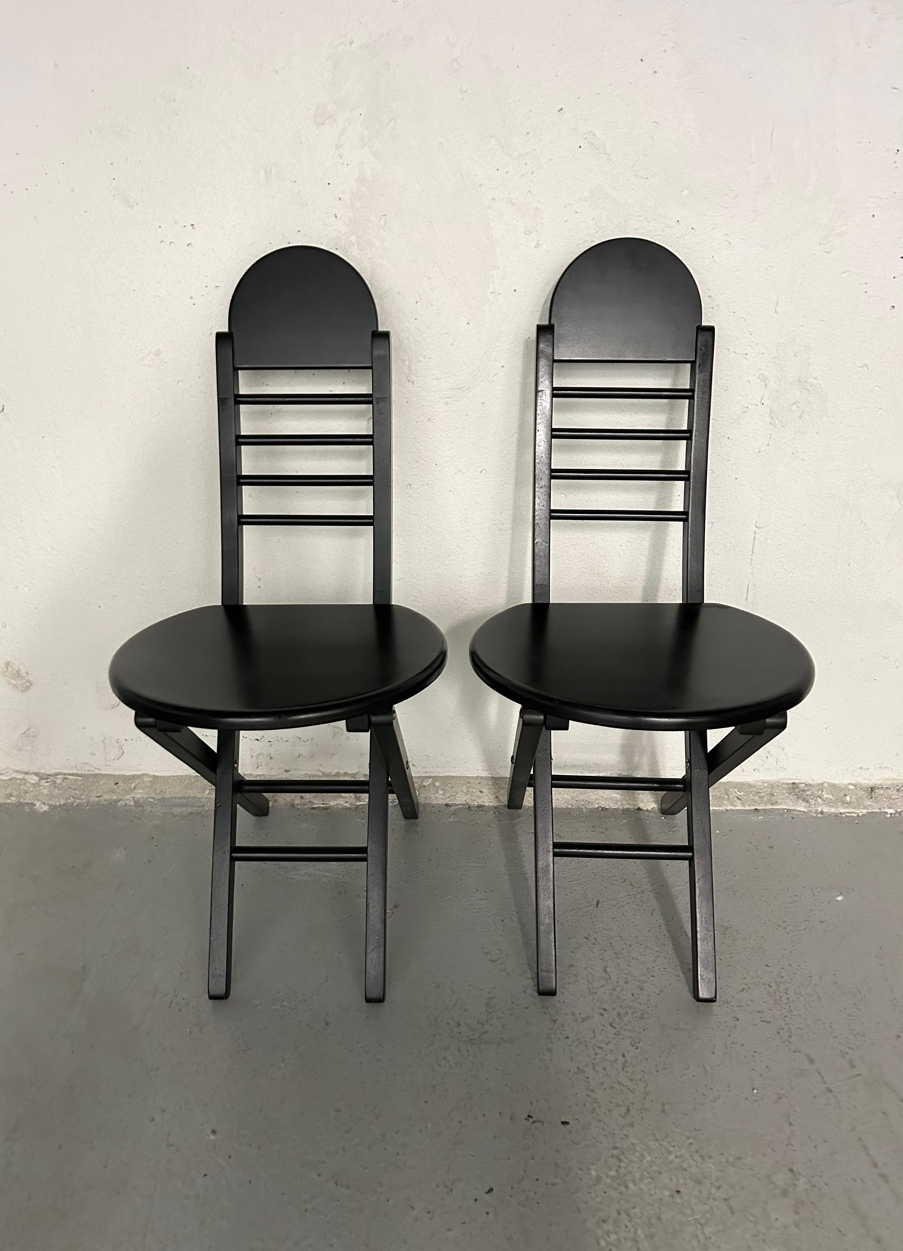 Set of 2 - Vintage 90s black painted wood folding chairs. Made in Thailand.
Normal vintage wear. 

35.5” chair height
19” seat height
16” width
19” depth