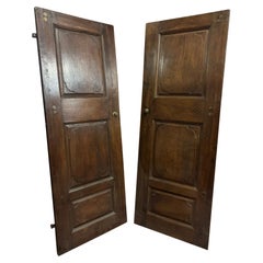 set of 2 walnut doors, one leaf with carved panels, Italy