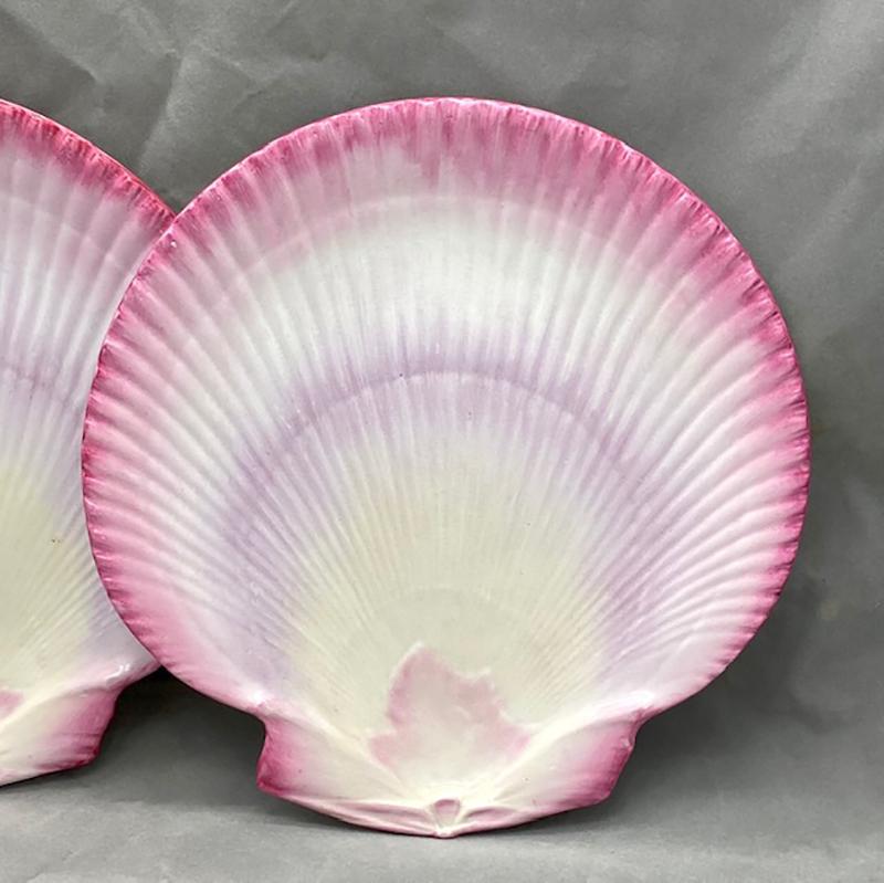 These two 19th century Wedgwood dessert scallop shaped dessert plates feature a shaded pink glaze that varies on each piece. The molded plates are realistically shaped as Josiah Wedgwood was fascinated by conchology/shells and remained true to the