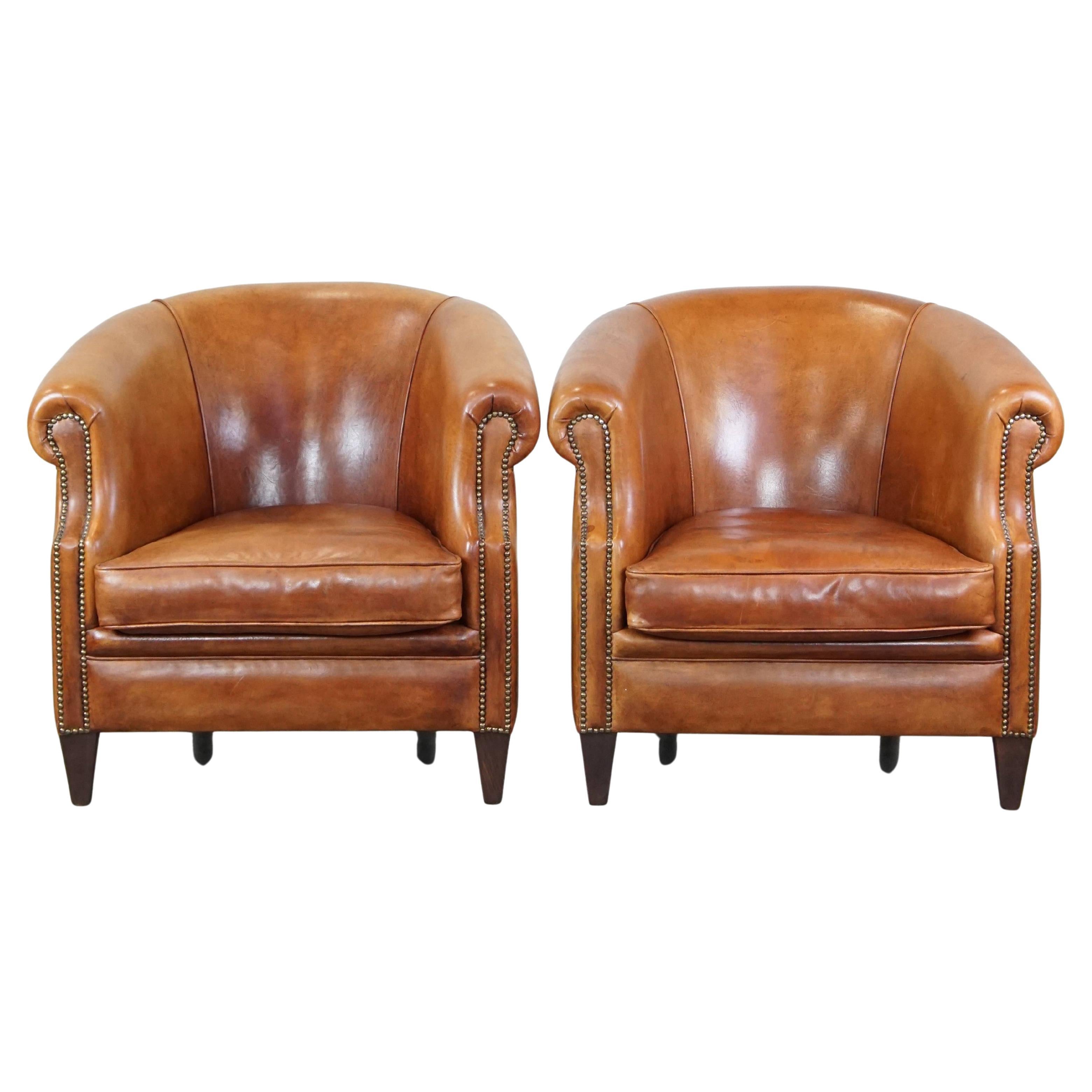 Set of 2 well-maintained sheepskin club armchairs with proper finishing