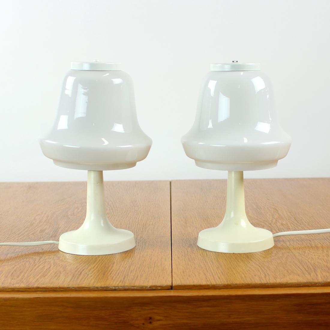 Set of two beautiful table lamps from midcentury era in elegant design. Produced by OPP Jihalava in 1960s, original labels still visible. The lamps are made of two basic components, off-white bakelite base and opaline glass white shade. The shade is
