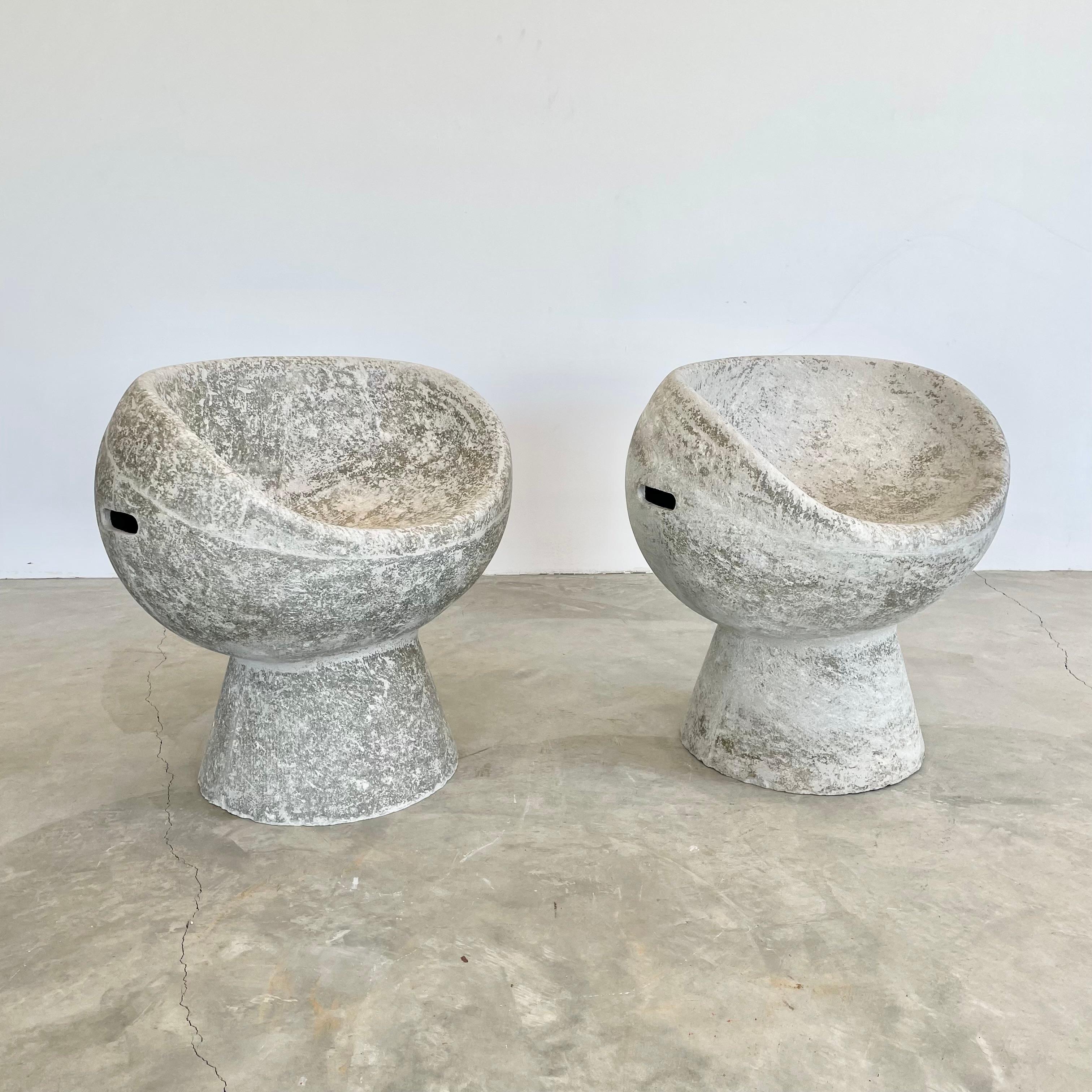 Stunning pair of concrete pod chairs designed by Swiss Architect Willy Guhl. Hand made in Switzerland by Eternit in the 1960s. Gorgeous patina. Factory drilled hole in seat for water to drain. Great sculptural pieces. Perfect for indoors or outside.