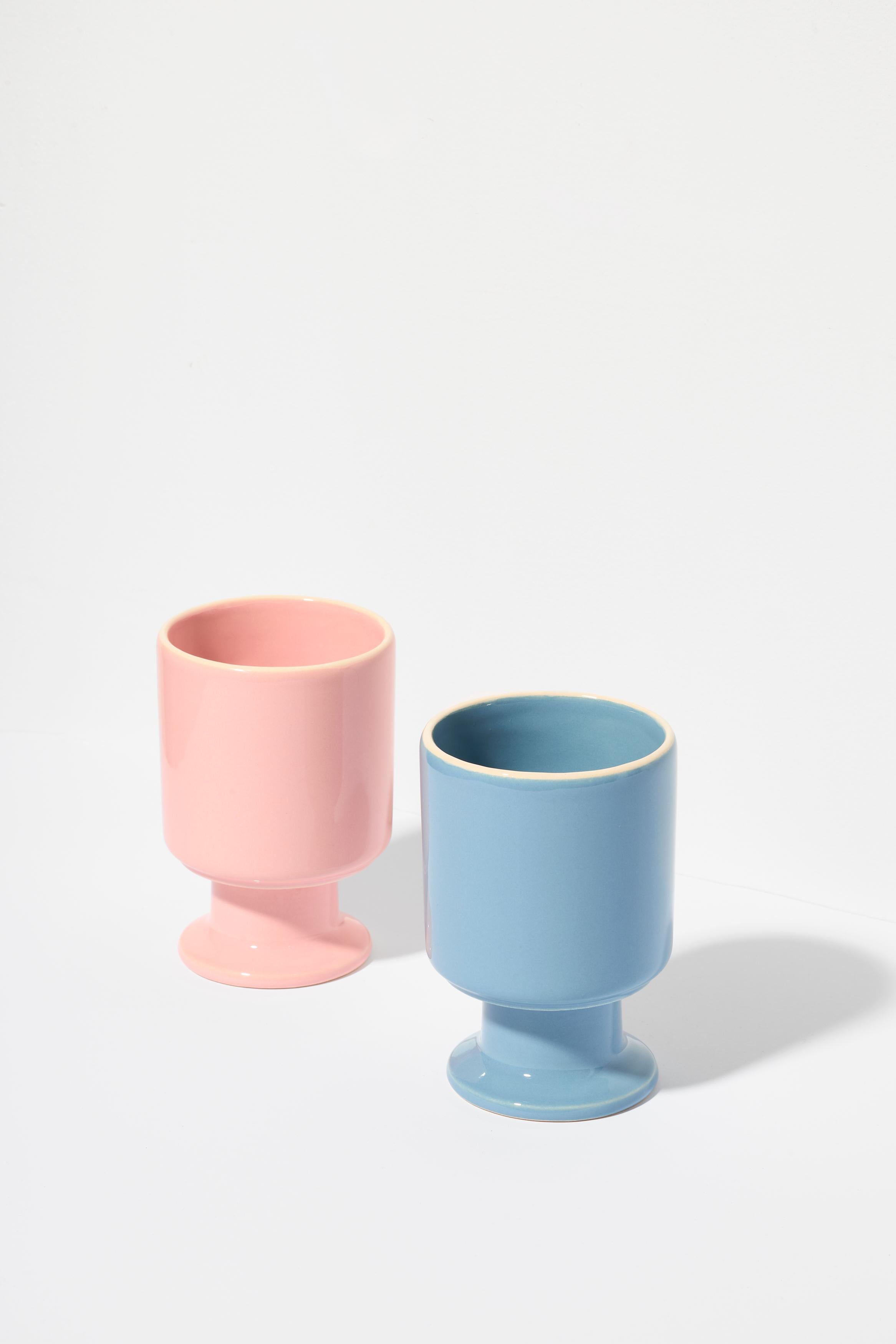 Set of two WIT cup Candy and Denim.

The WIT cup is a multifunctional vessel with a playful stem. It can become your favorite coffee cup, a dessert bowl, a container for pens, or other favorite accessories. WIT chalices can be stacked to create