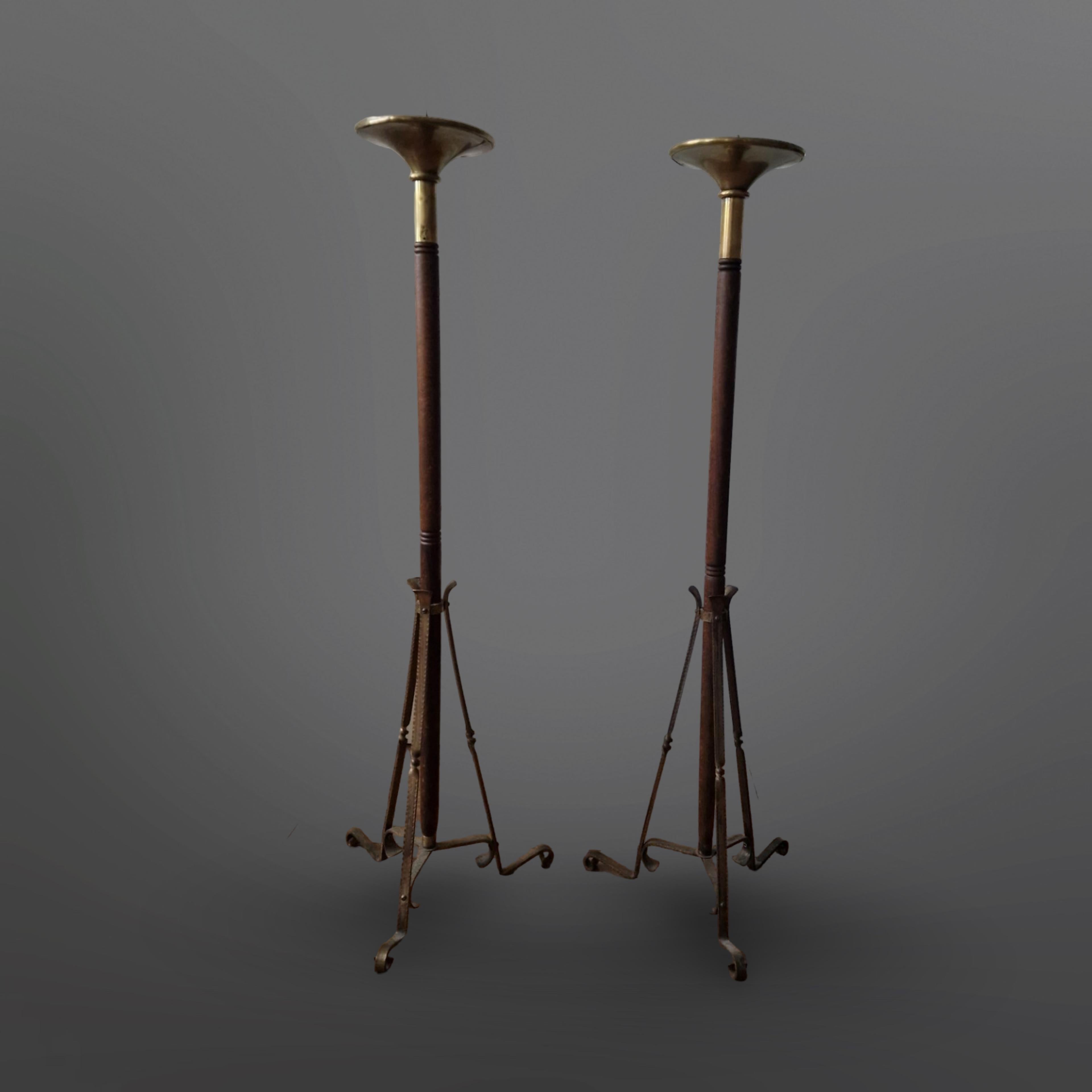 Set of 2 floor standing candle holders. Made from wood and brass. They came from a monastery in Oirschot Netherlands

The bases are made from wrought brass. The candle holders are made from wood with a brass flared top. The candle holders were