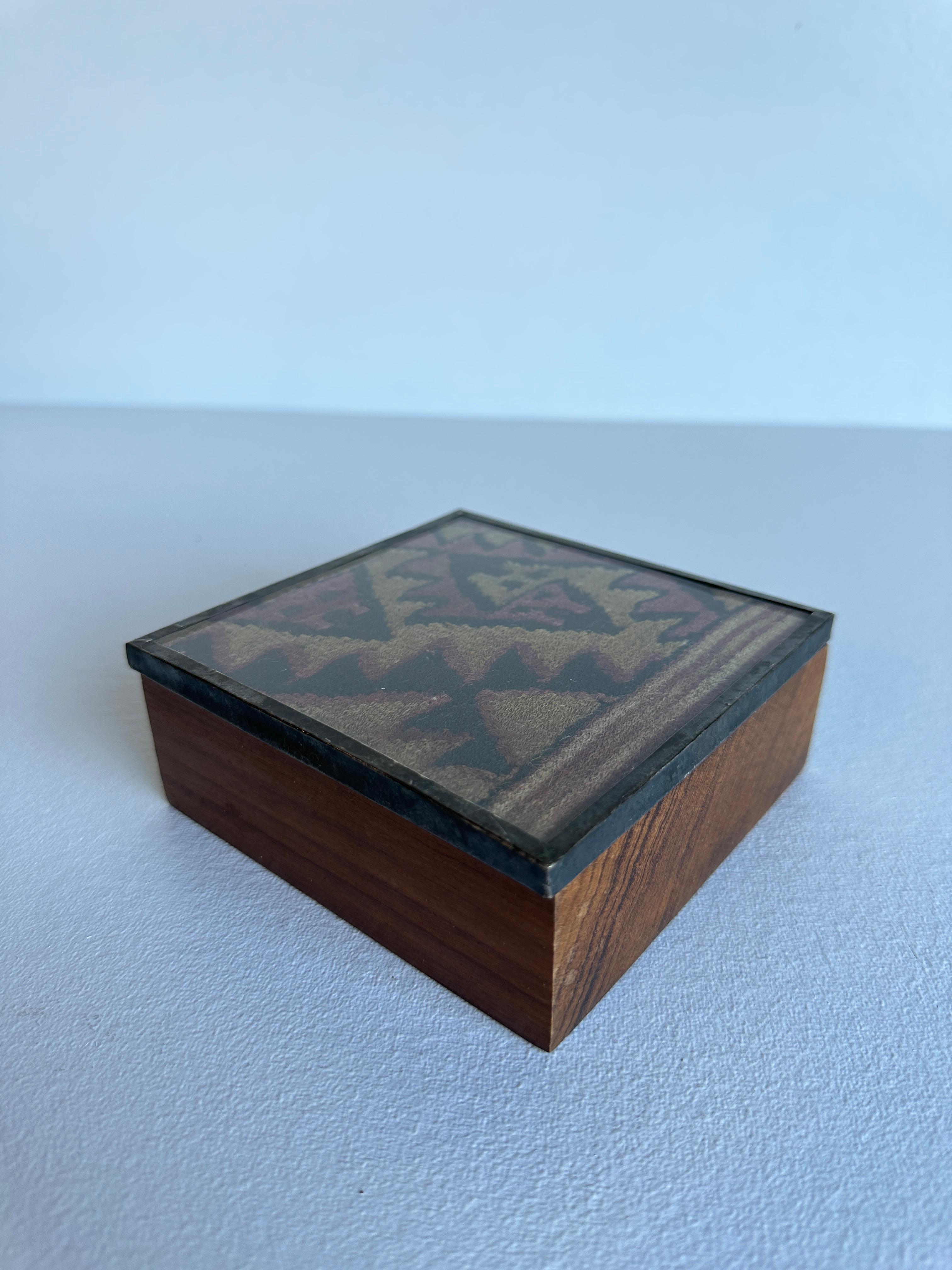 Set of 2 Wood and Sterling Silver Boxes with Pre-Columbian Fabric Remnants 

Box #1 measures 6 x4.5x1.5”
Box #2 measures 5x5x2” 