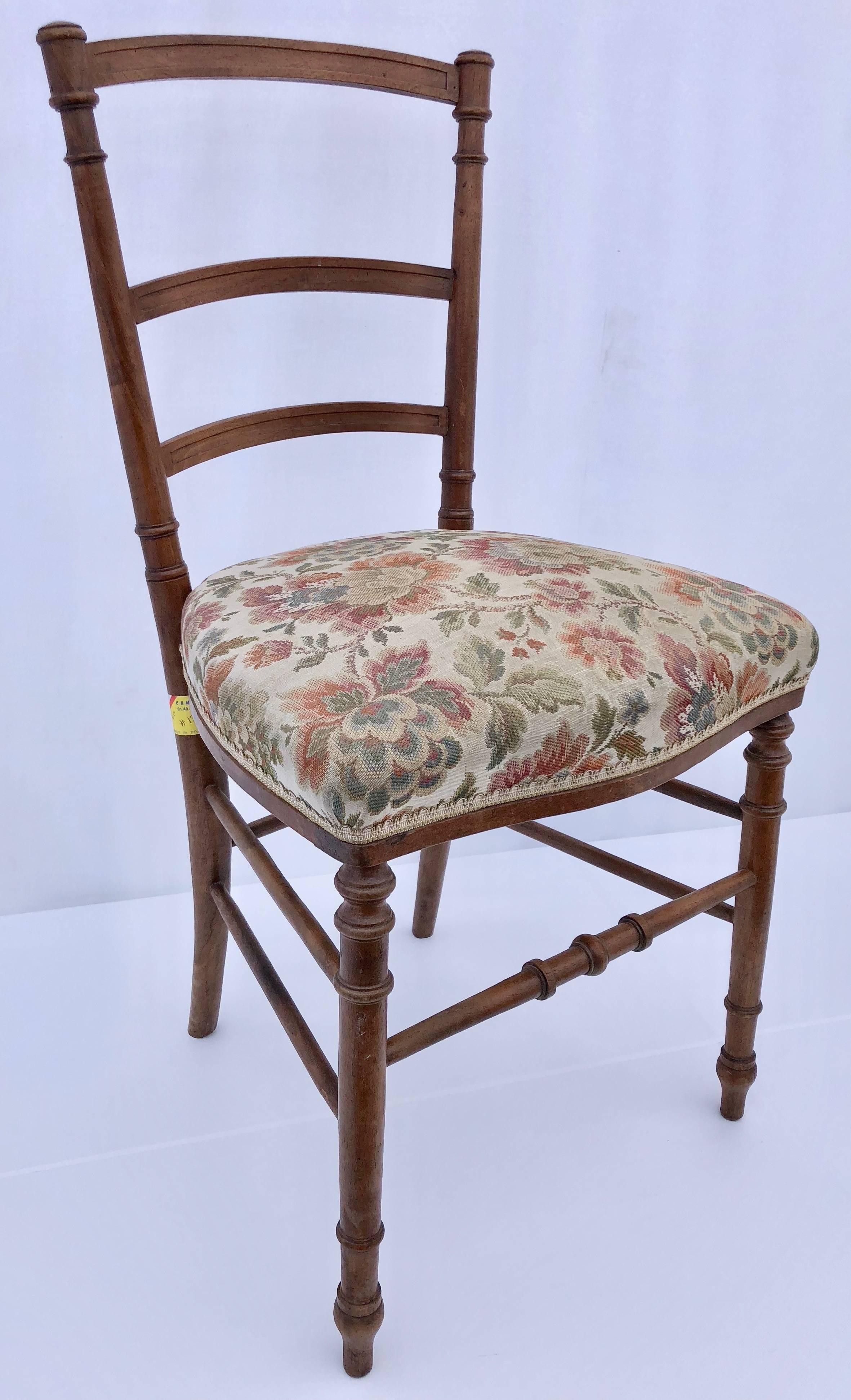 These two Napoleon III chairs are simply beautiful. One is natural wood with a an antique floral upholstery and trim, with a slightly wider seat and the other is black hand painted wood with an off-white and pale grey upholstery in a floral design