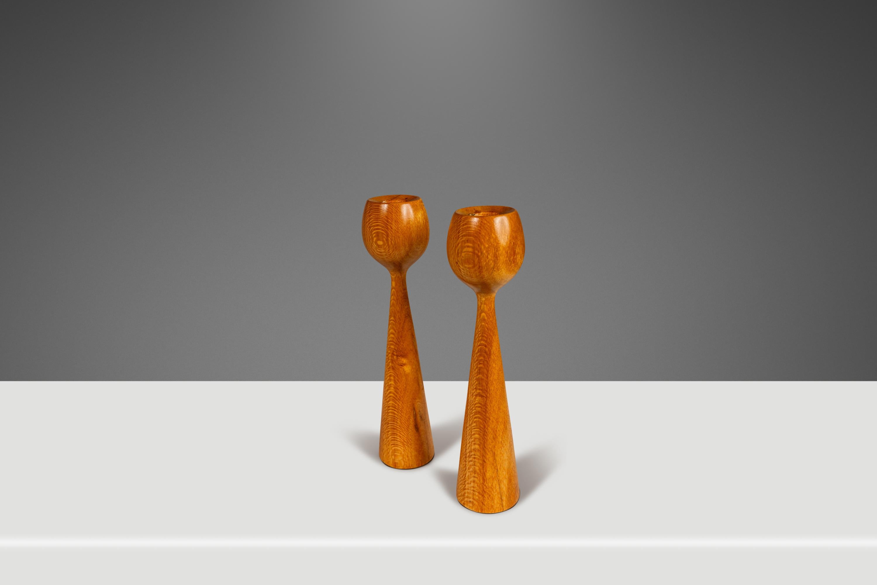 Introducing a quintessentially Danish Modern set of wood-turned candlestick holders carved from solid blonde ash. Replete with stunning old-growth woodgrains, elegantly sculpted flared tulip tops and perfectly balanced this gorgeous hand-crafted set